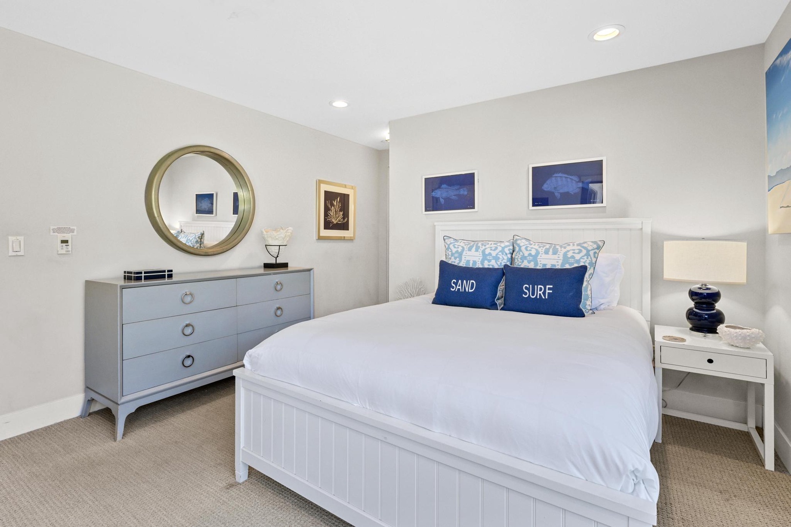 Your coastal retreat awaits with crisp white linens, nautical blues, and beachy accents—a serene space where you'll drift off dreaming of sand and surf.
