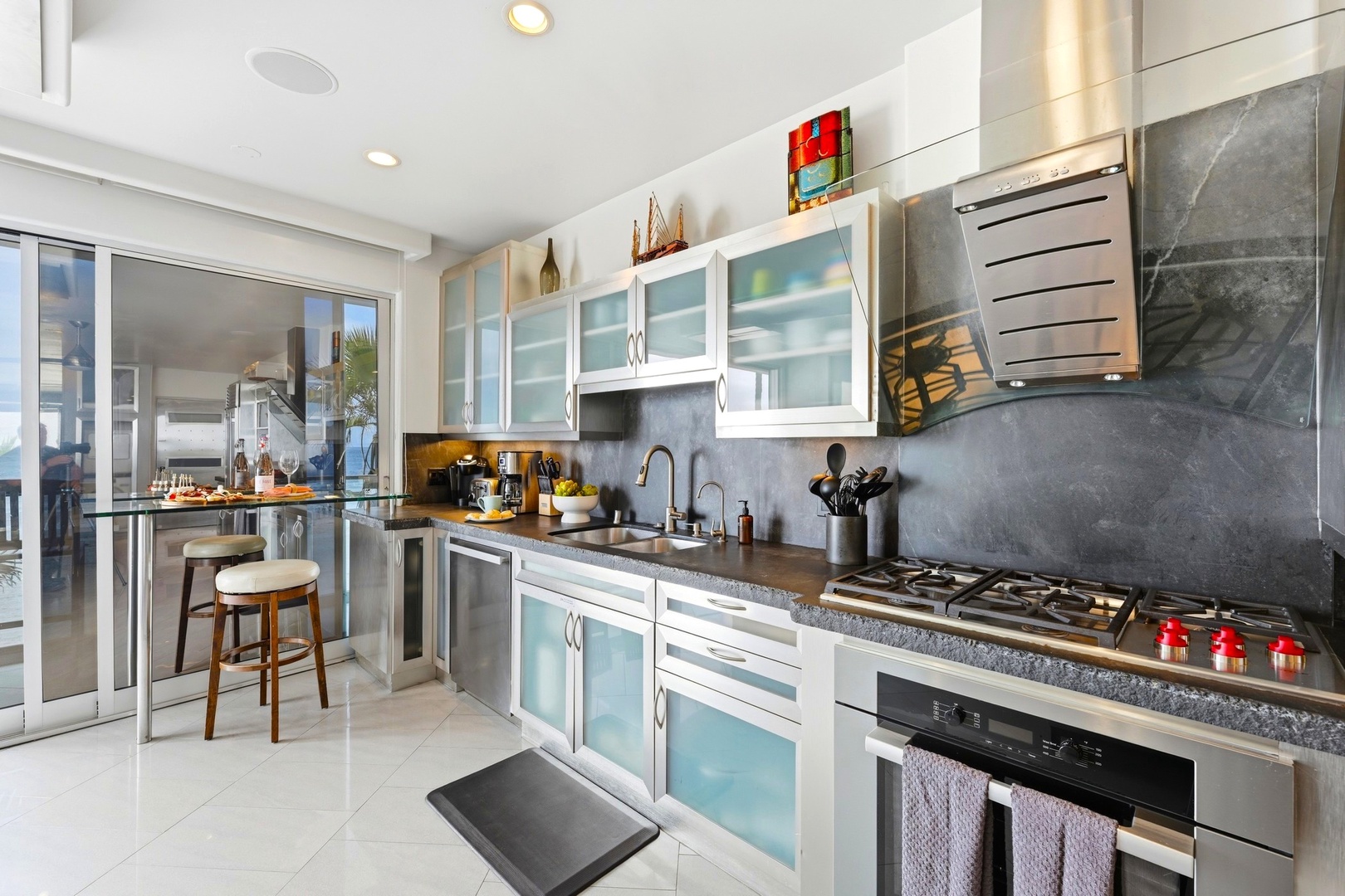 Sleek glass cabinets, granite counters, and stainless appliances