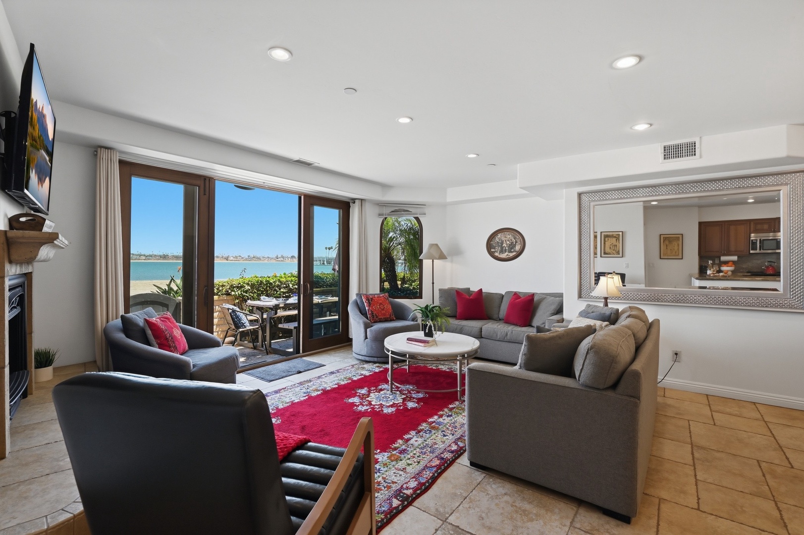 Relax in your waterfront living room where panoramic bay views and plush seating create the perfect retreat after beach days.