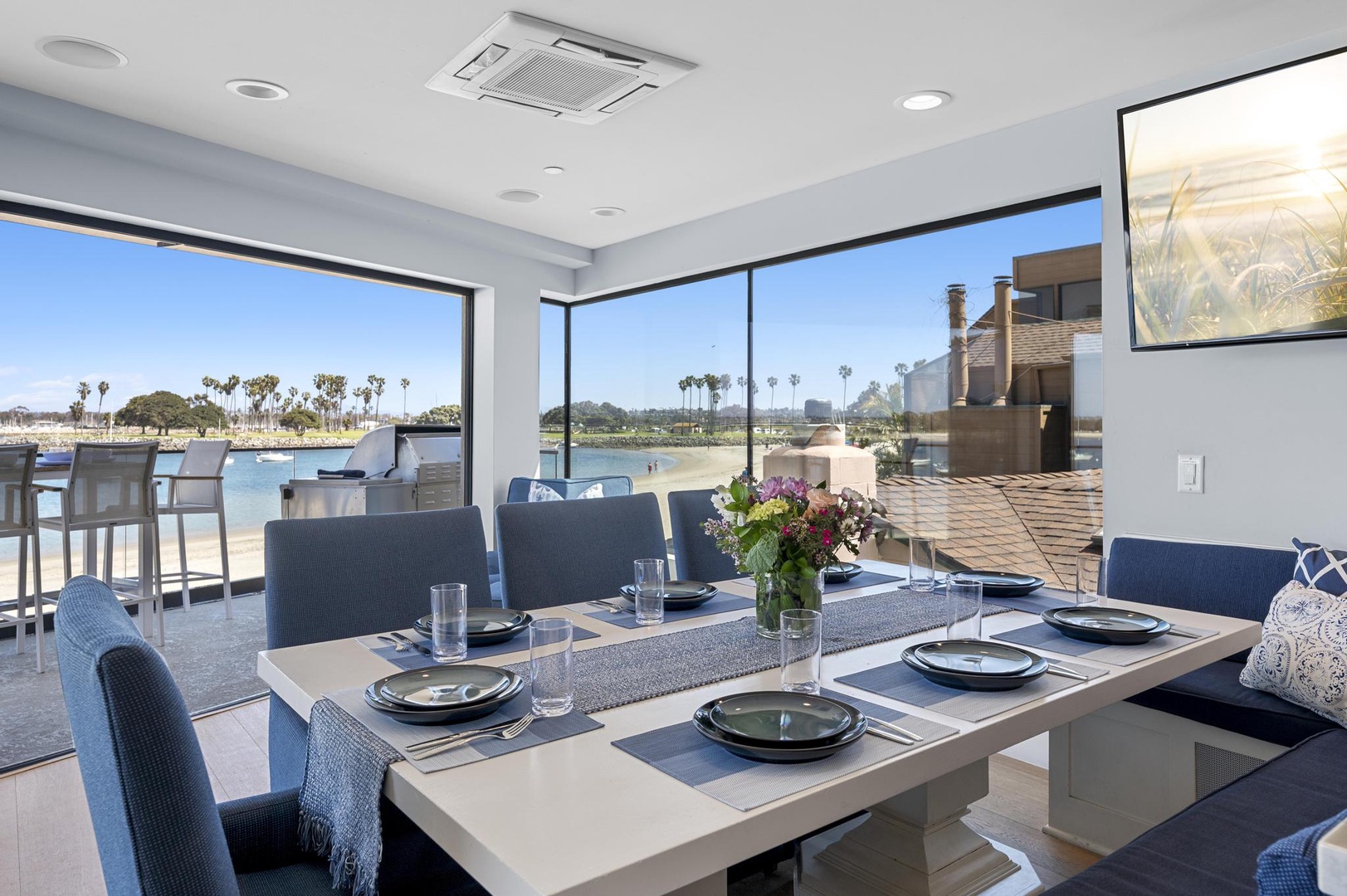 Gather with friends around your dining table and take in stunning waterfront views through floor-to-ceiling windows.