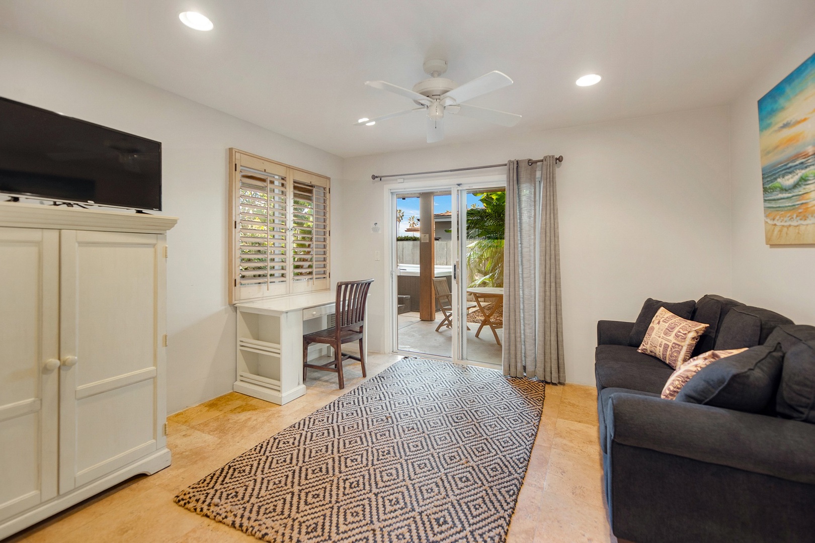 Den with work desk and TV