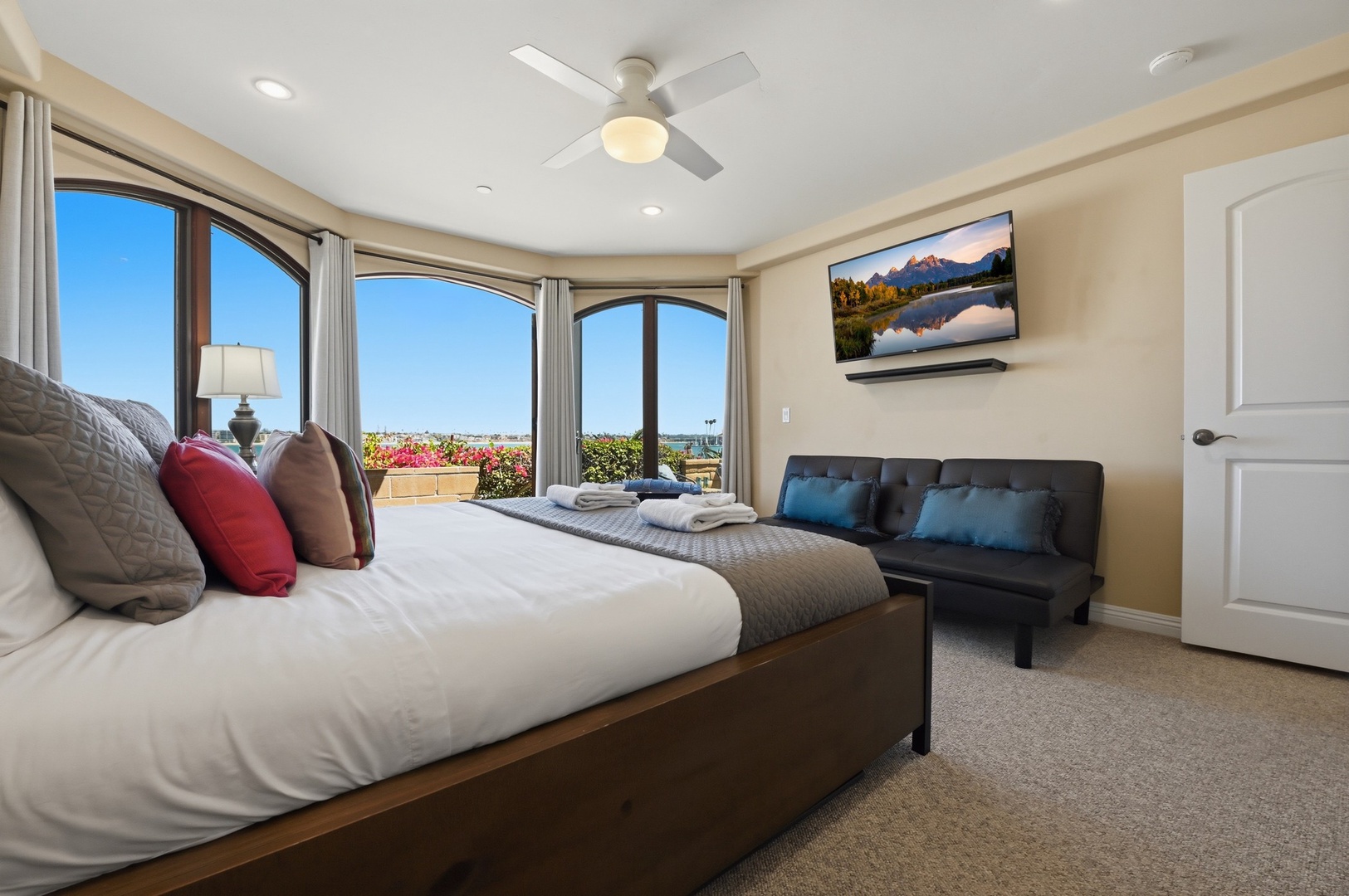 Wake up to panoramic views from your comfortable bedroom, complete with a ceiling fan and cozy seating nook for relaxation.