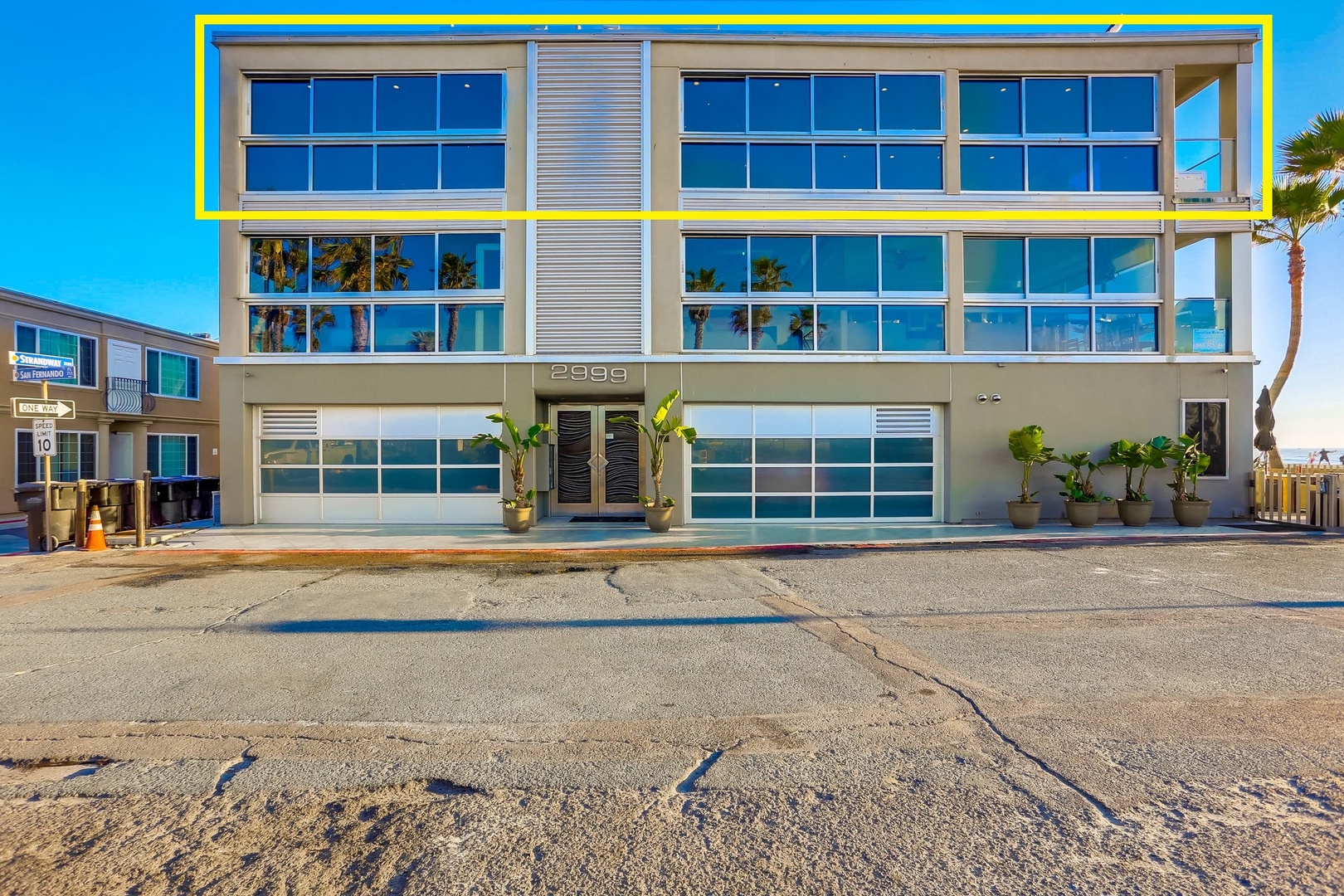 Top floor of a modern three-story beachfront property