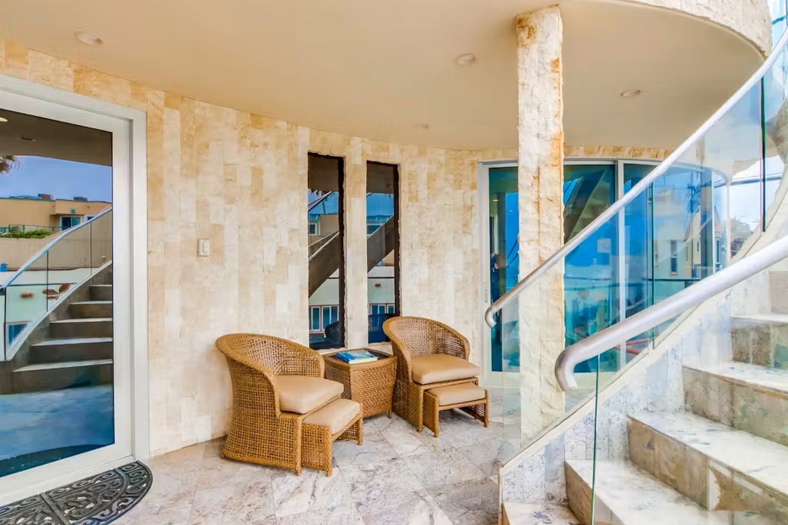 Step onto your private balcony where wicker chairs invite you to sink in and soak up ocean breezes. The elegant stone-clad design creates a serene retreat for your morning coffee or sunset cocktails.