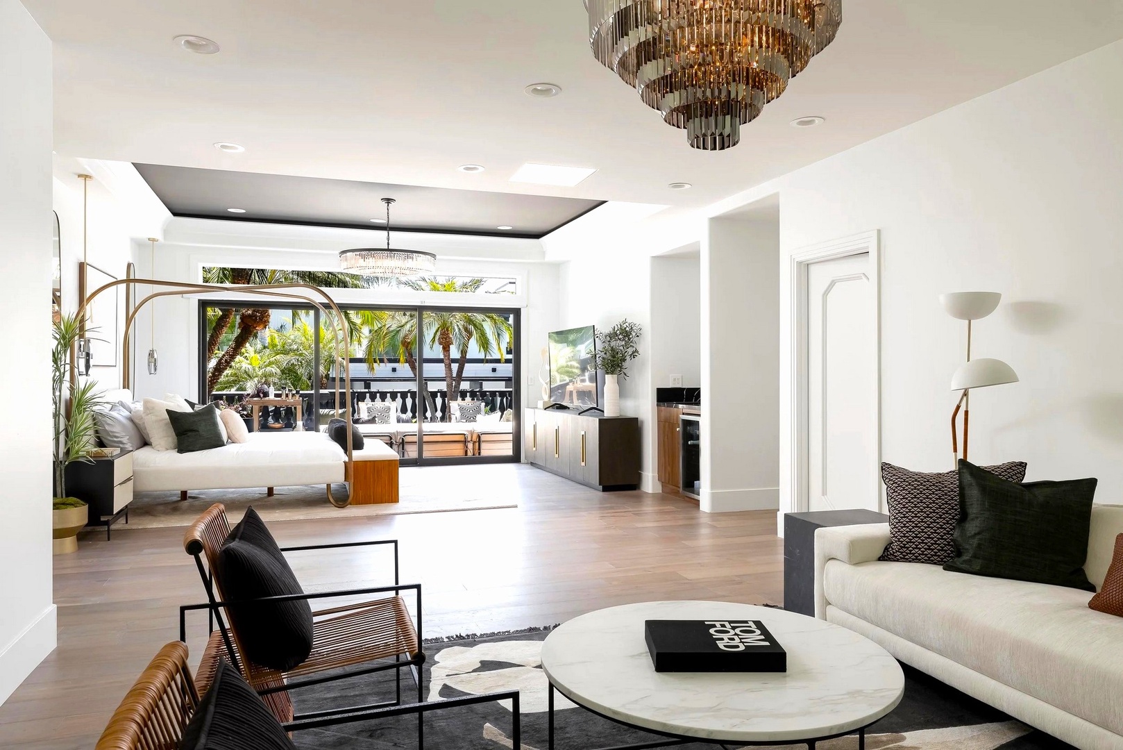 Step into your elegant living room where modern luxury meets comfort. Natural light floods through floor-to-ceiling windows while you relax under stunning chandeliers.