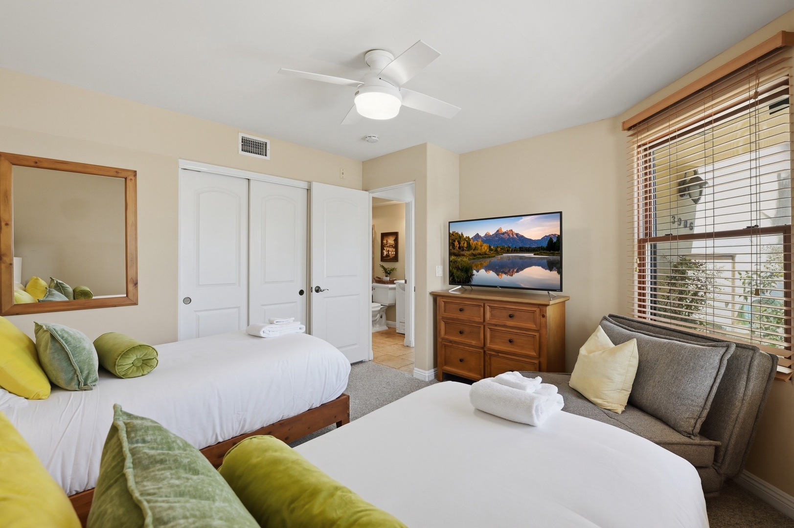 Unwind in your comfortable bedroom with two cozy beds, nature views on the flat-screen TV, and a peaceful atmosphere perfect for restful nights.