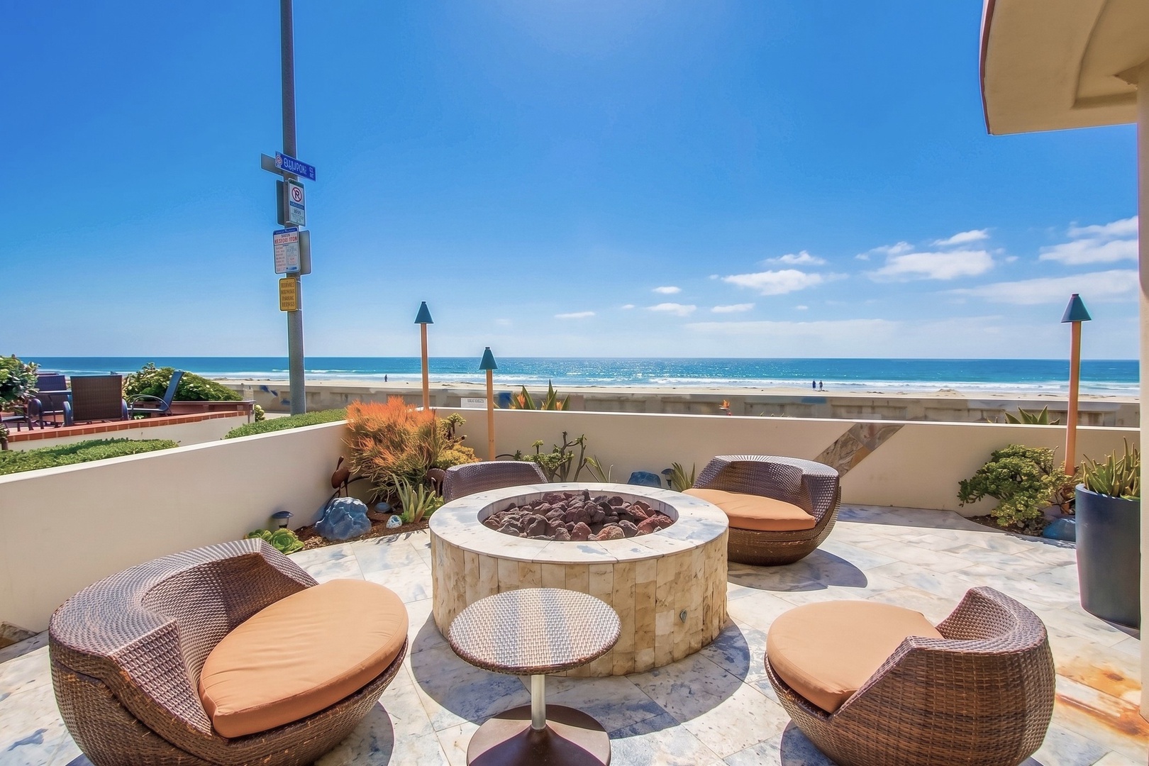 Oceanfront terrace with a fire pit