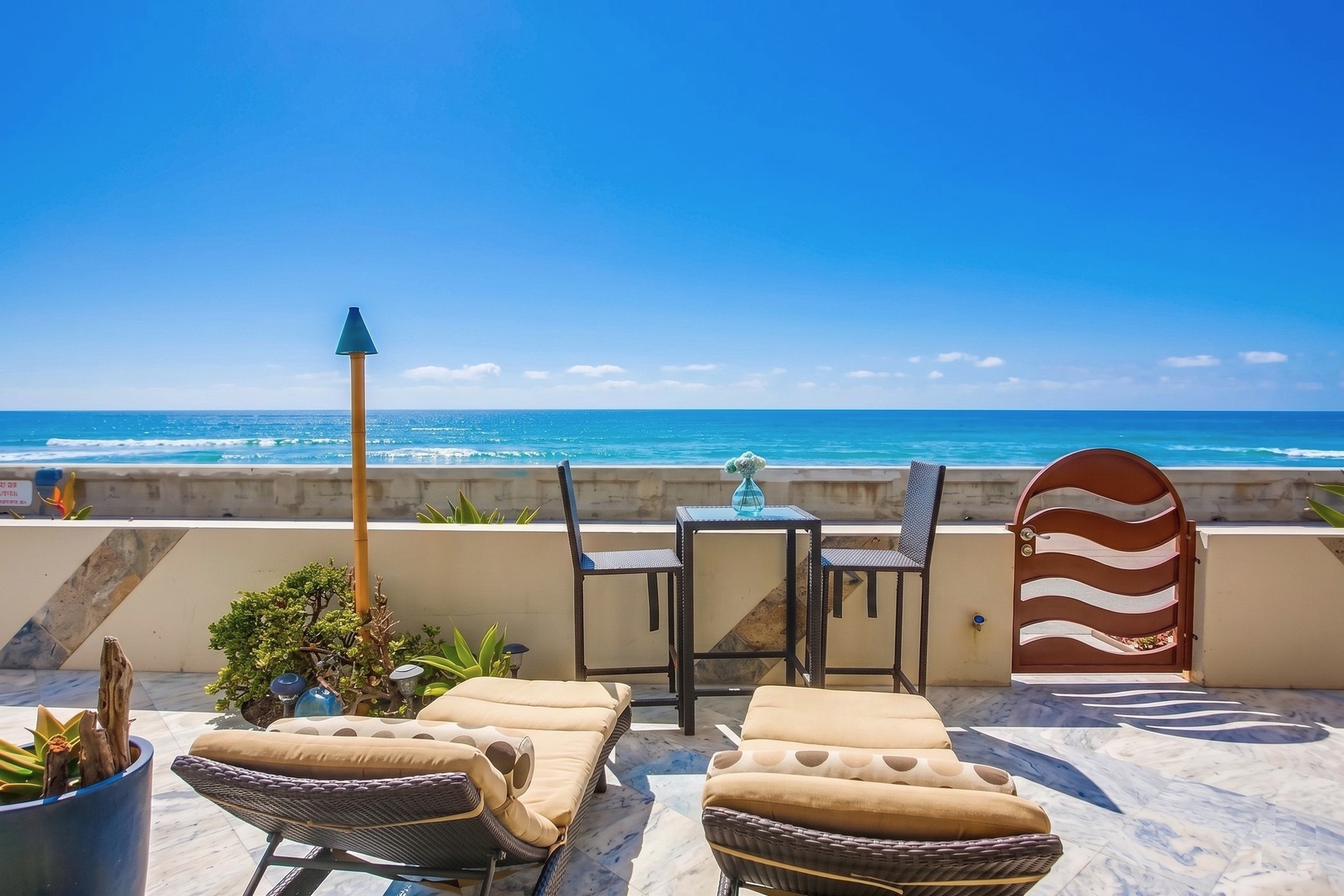Beachfront patio overlooking the brilliant blue ocean