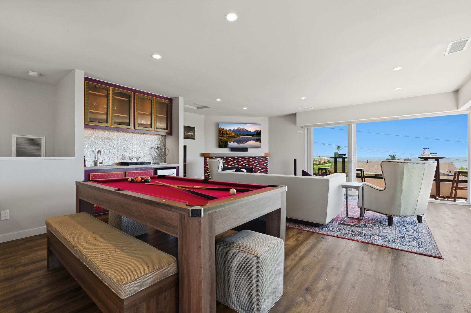 Challenge friends to pool games in your stylish entertainment space, with ocean views creating the perfect backdrop for fun.