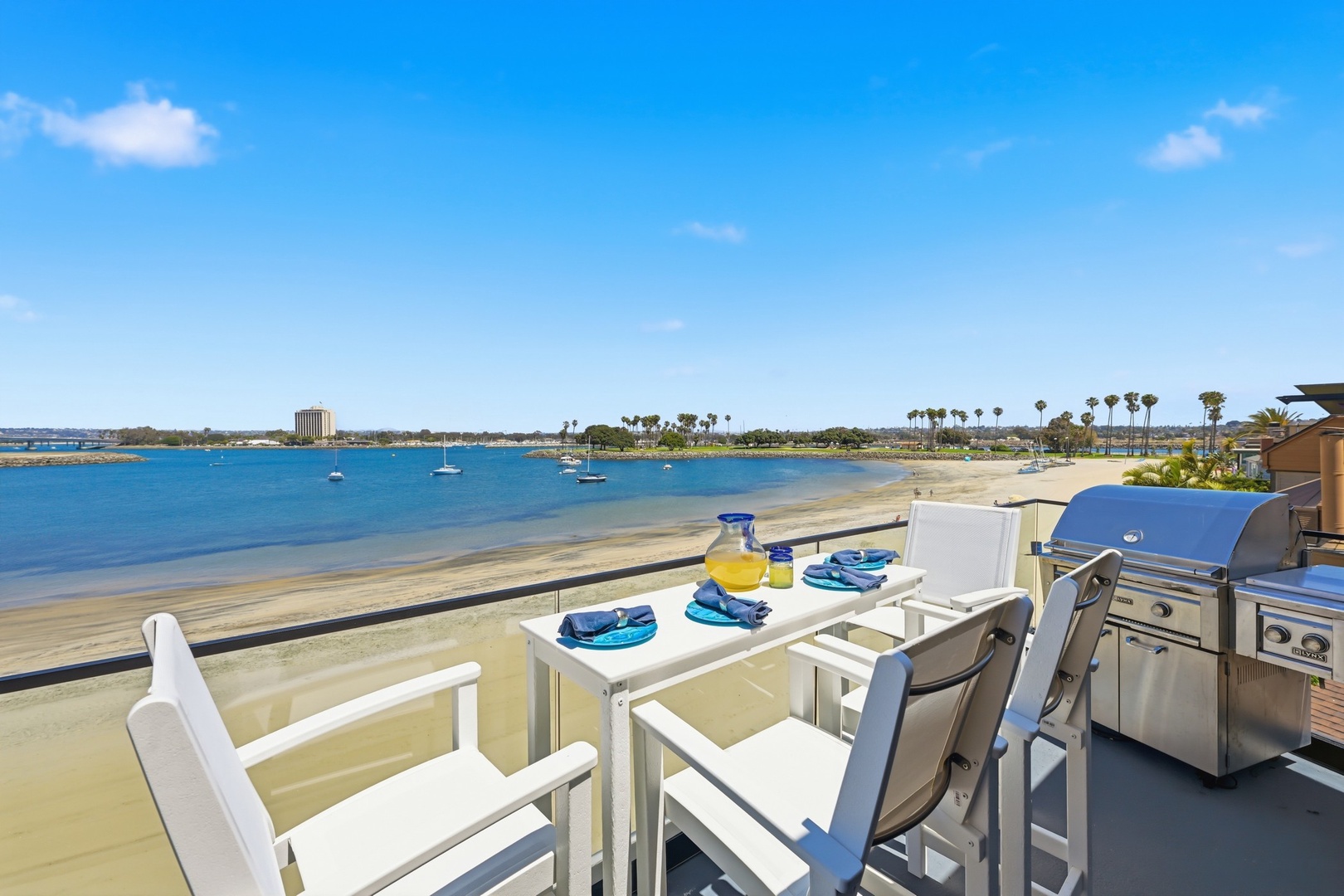 Beachfront balcony with BBQ and dining table