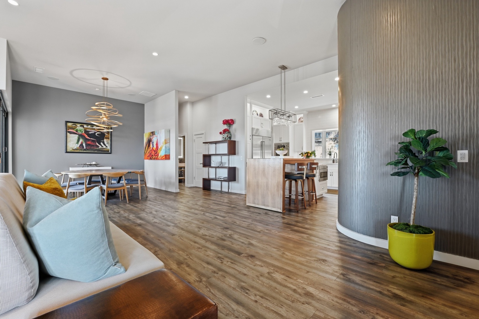 Settle into this stunning open-concept space where modern design meets comfort, featuring soaring ceilings and rich hardwood floors throughout.