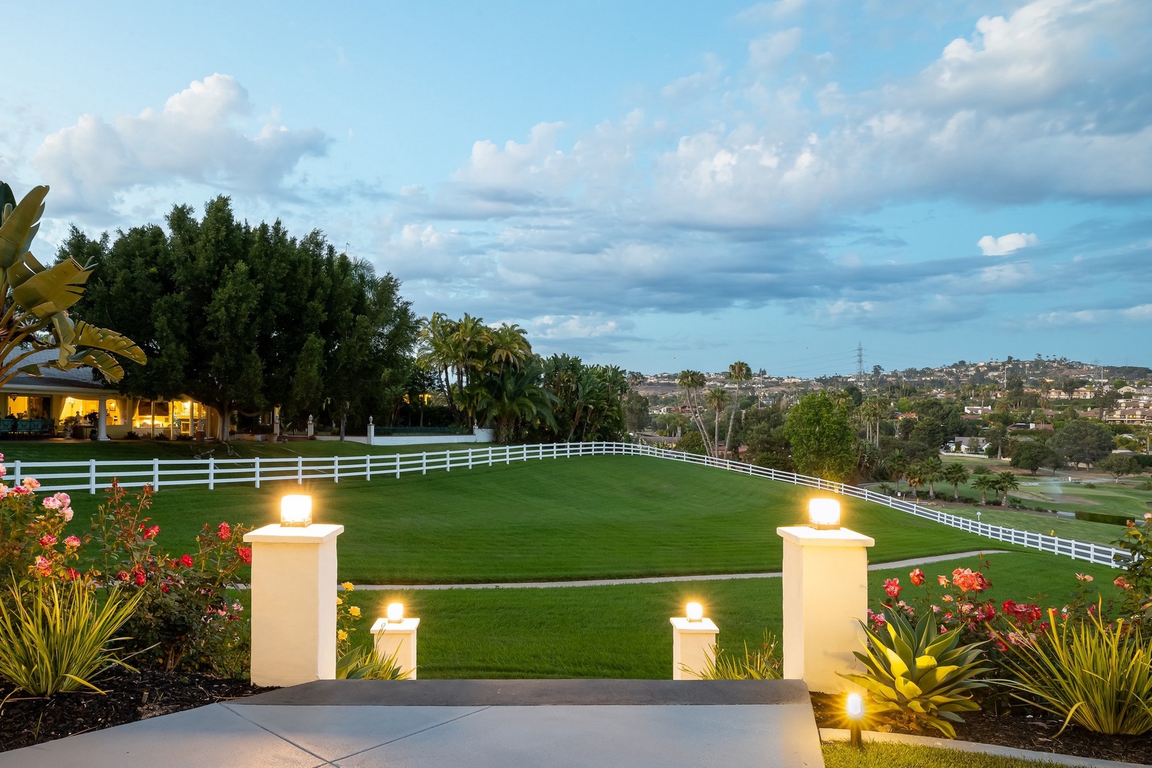 Landscaped lawn with rolling hillsides and palm trees