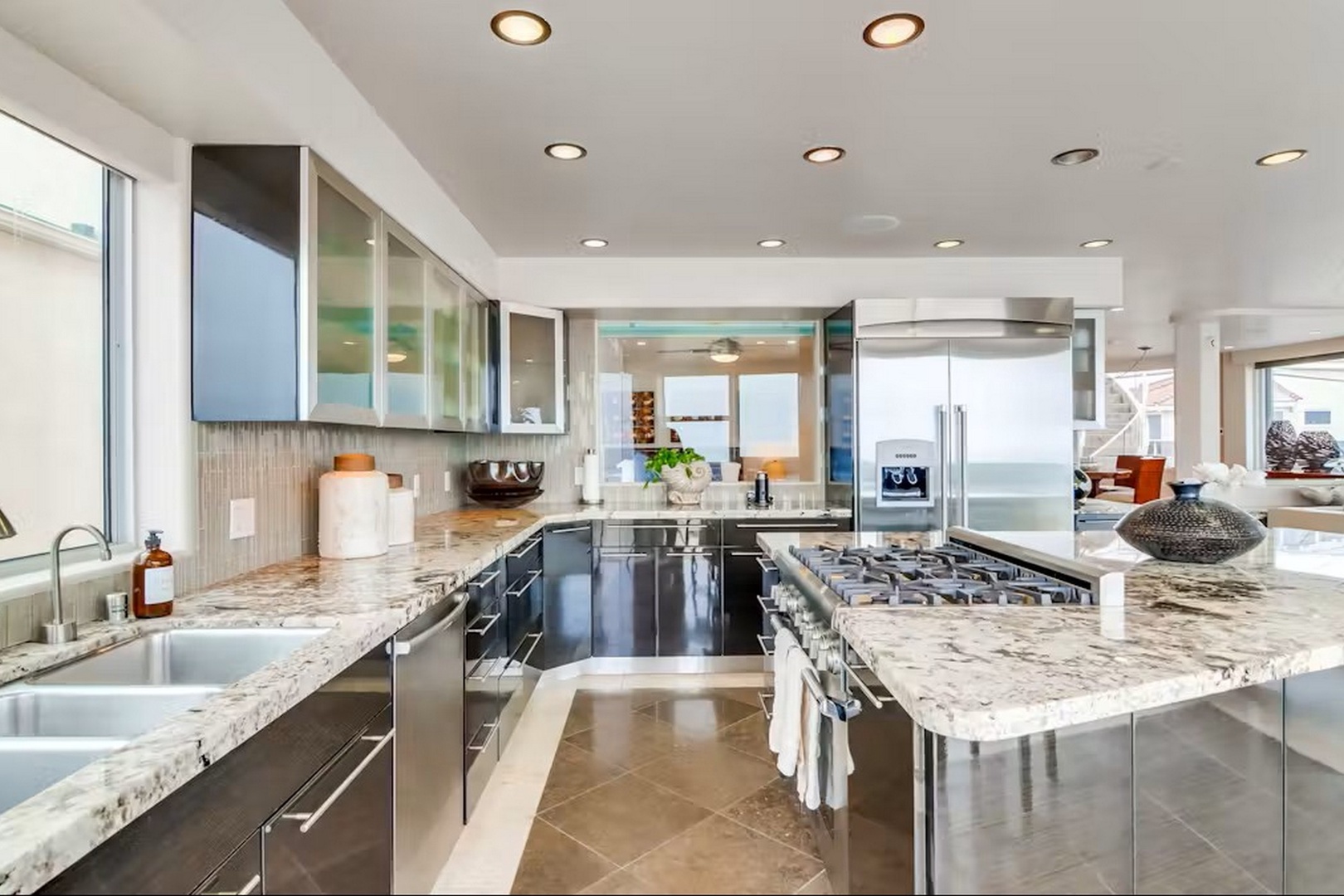 Step into this modern chef's dream, where gleaming granite countertops and top-tier appliances invite you to create delicious meals with ease and style.