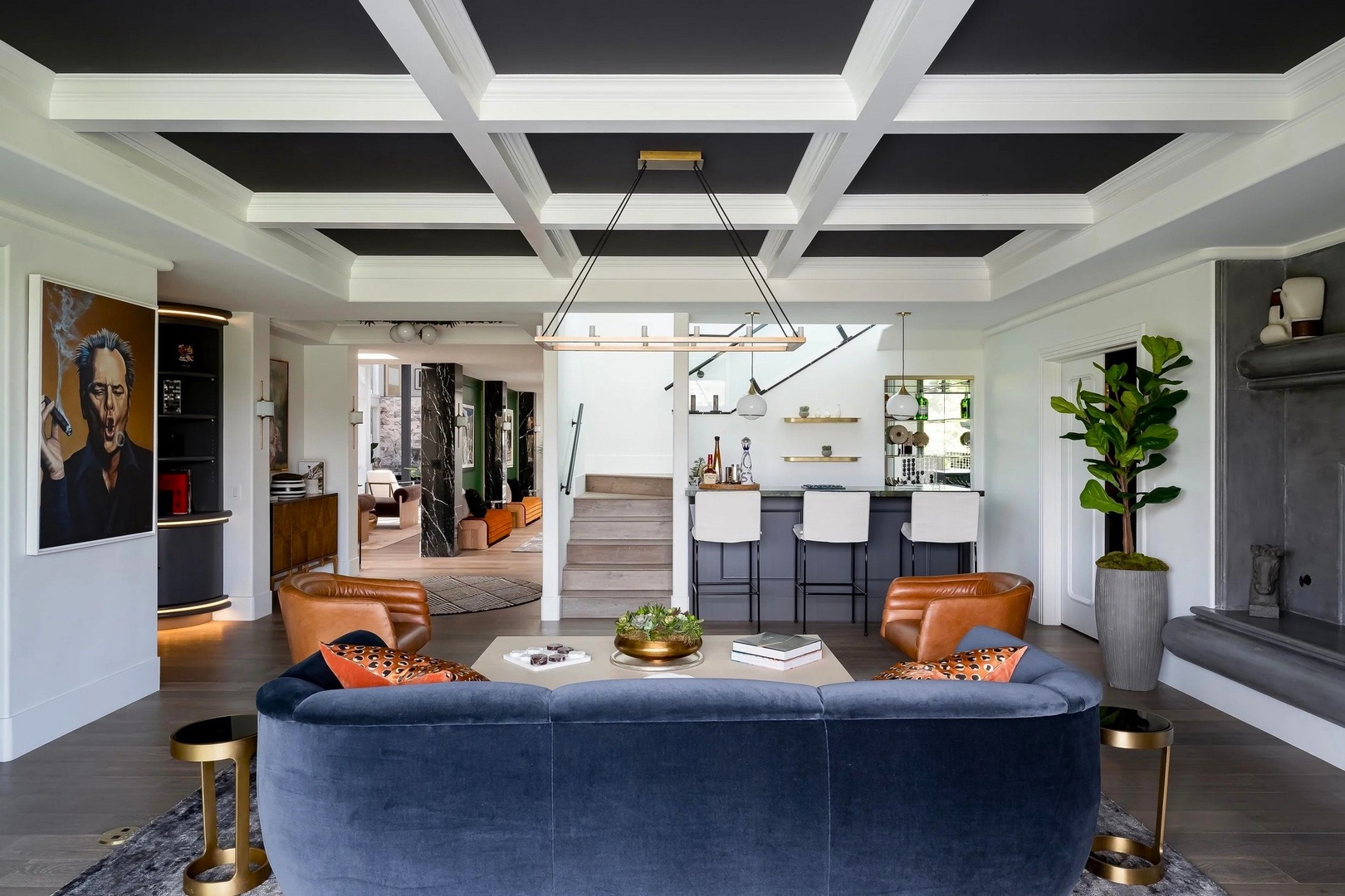 Sink into the plush velvet sofa and soak in this stunning open-concept space where modern luxury meets artistic flair.