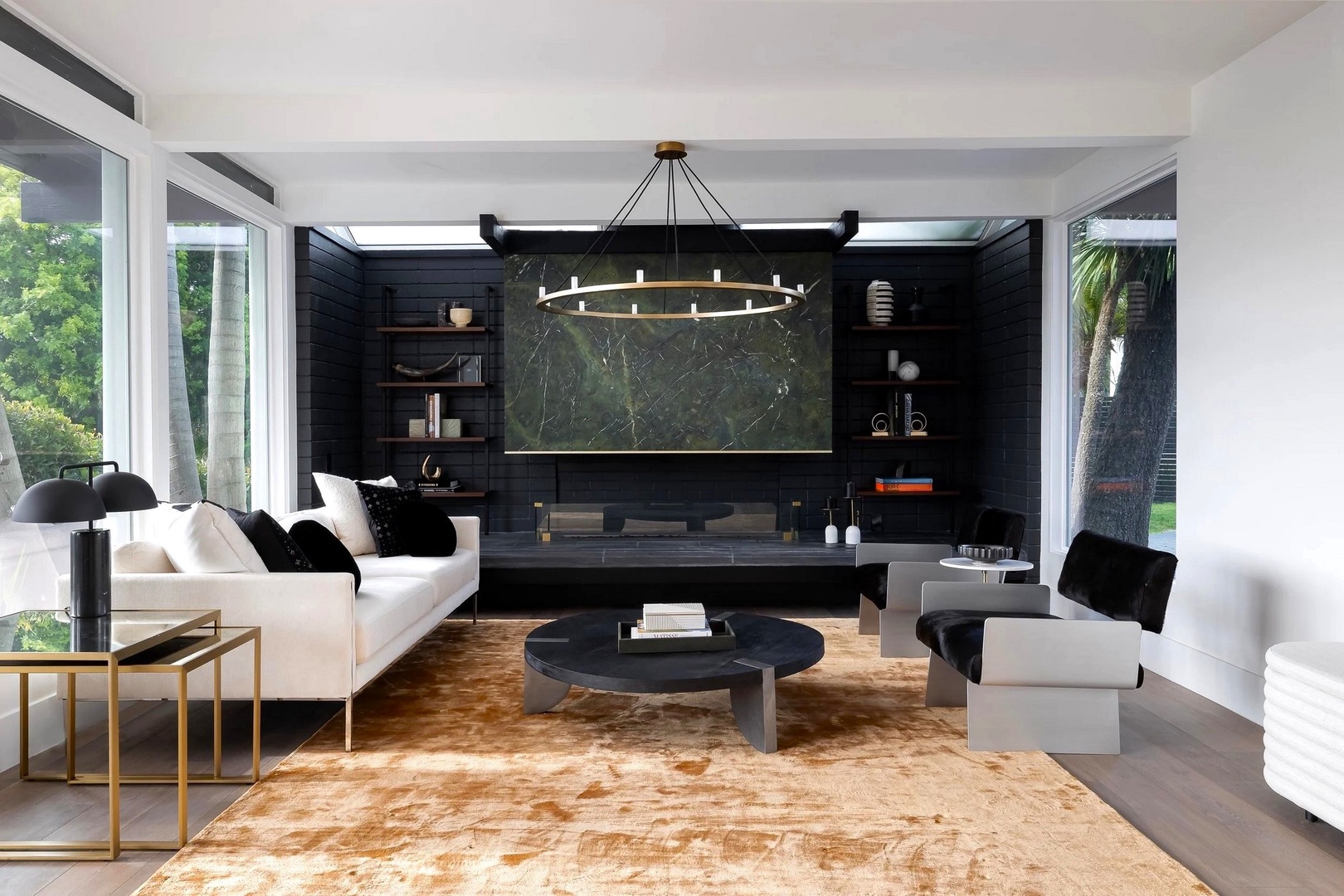 Relax in this striking contemporary living room with floor-to-ceiling windows, elegant marble accents, and plush seating perfect for unwinding.