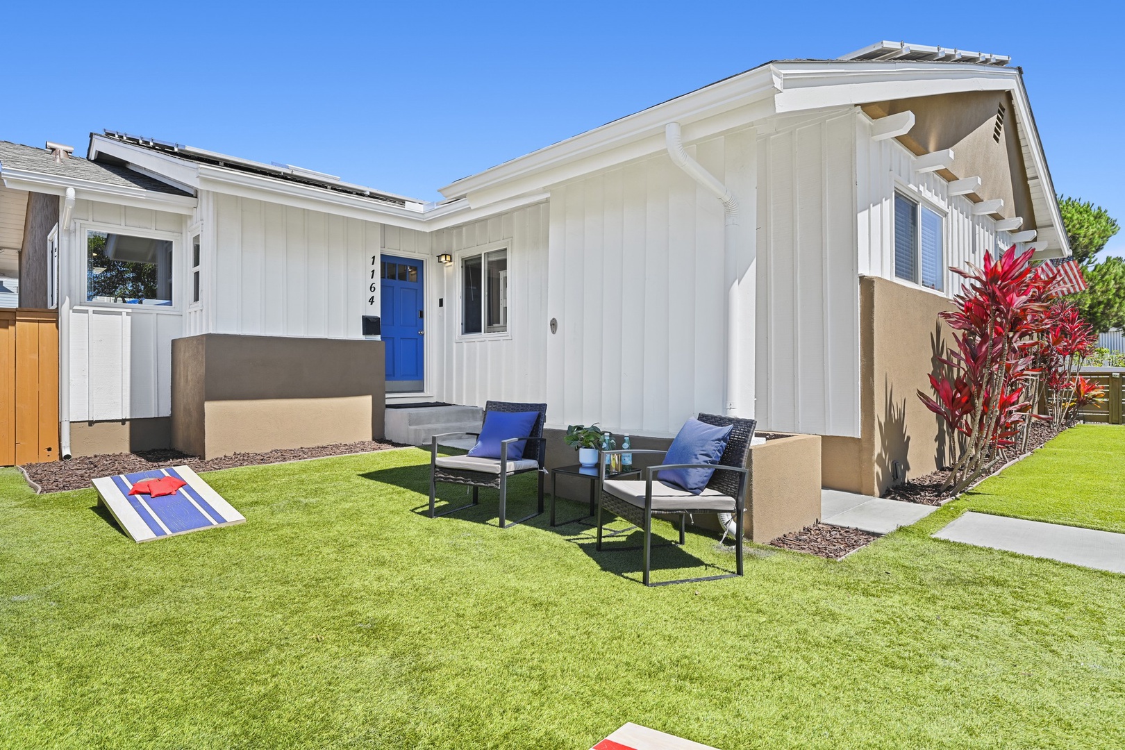 Front yard with cornhole