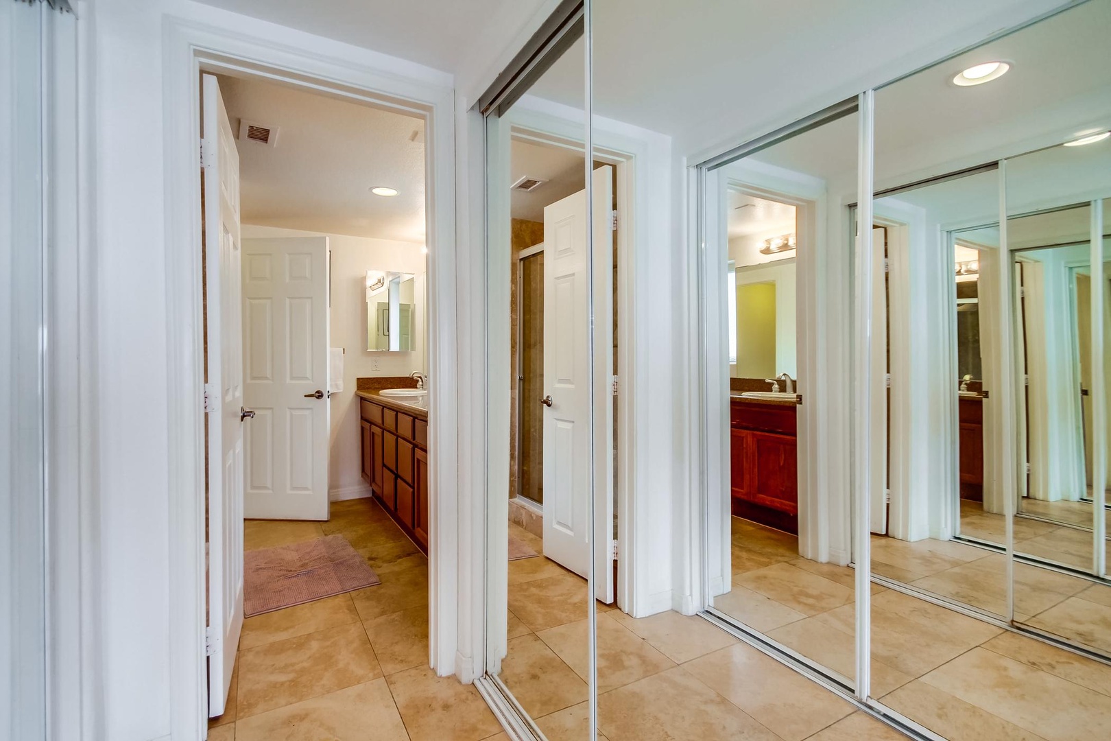 Hall closets in primary bedroom