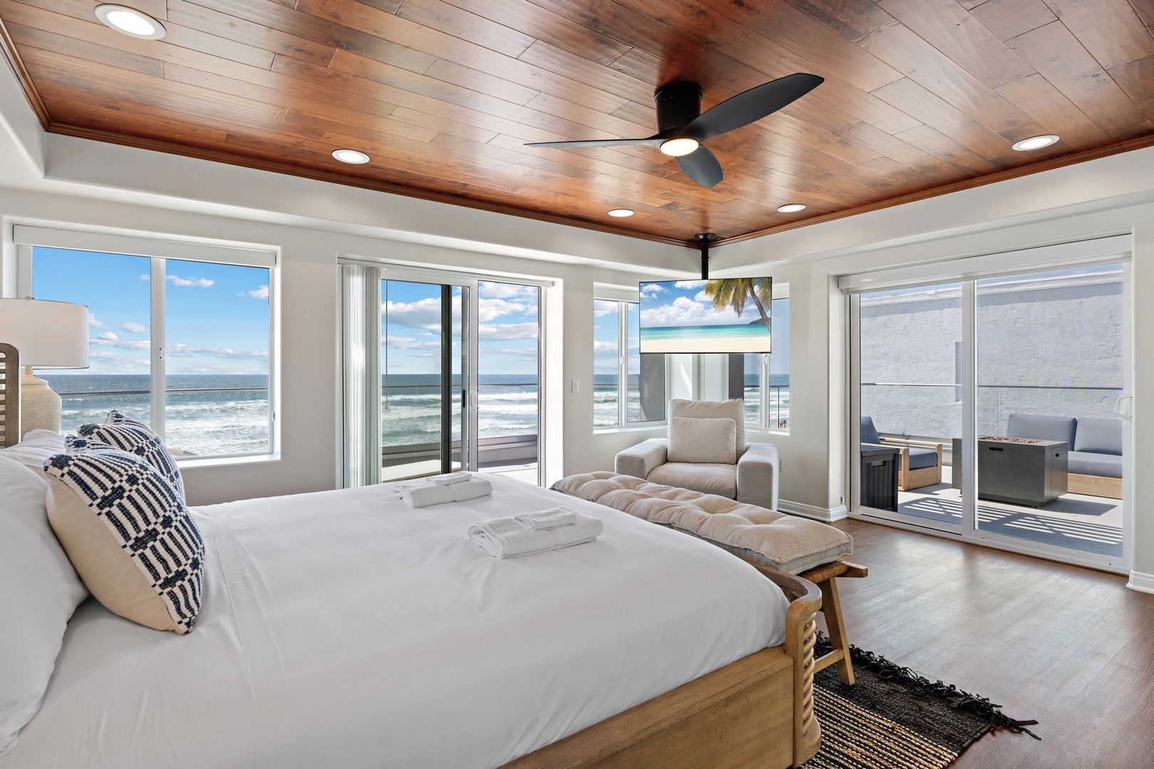 King bed with TV and ceiling fan