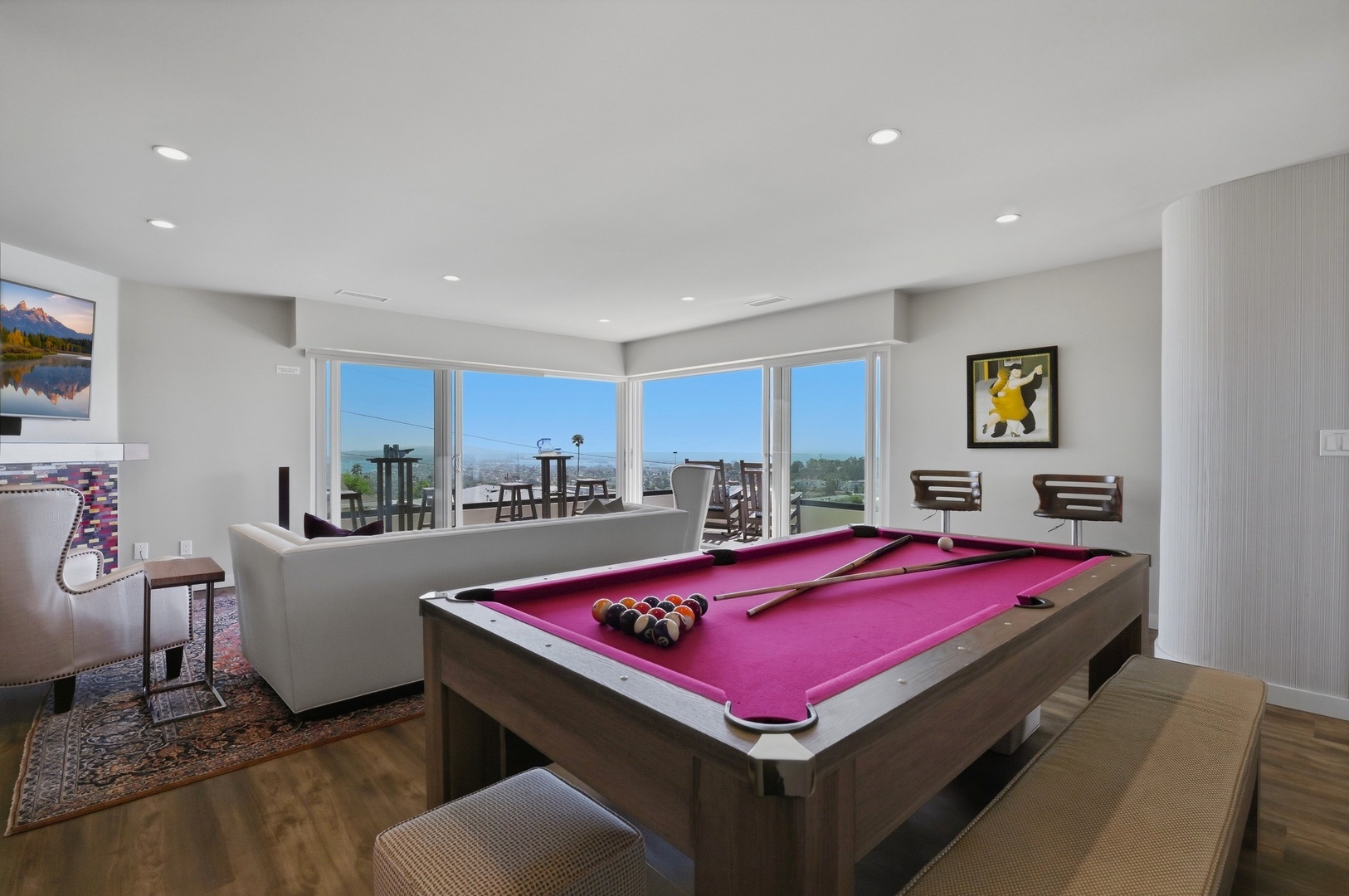 Challenge friends to a game at your sleek pool table while enjoying panoramic views through floor-to-ceiling windows.