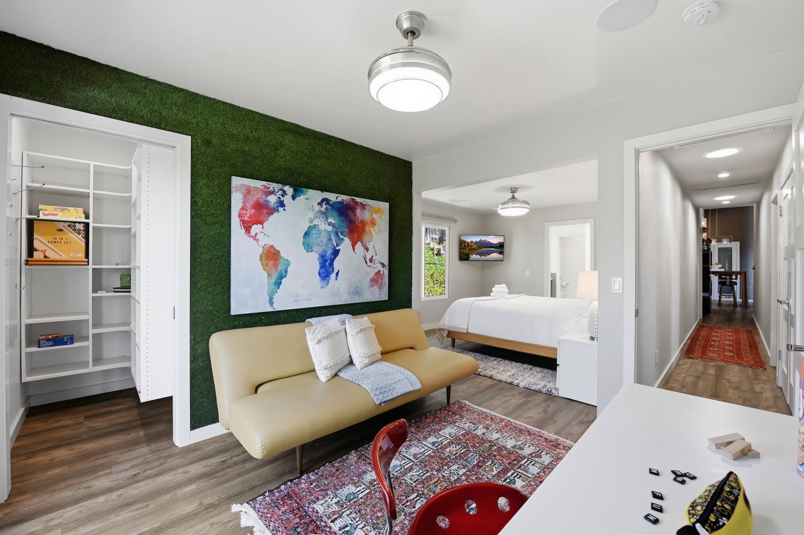 Your stylish studio features a striking green accent wall, modern seating, and thoughtful details that create a welcoming space for relaxation.