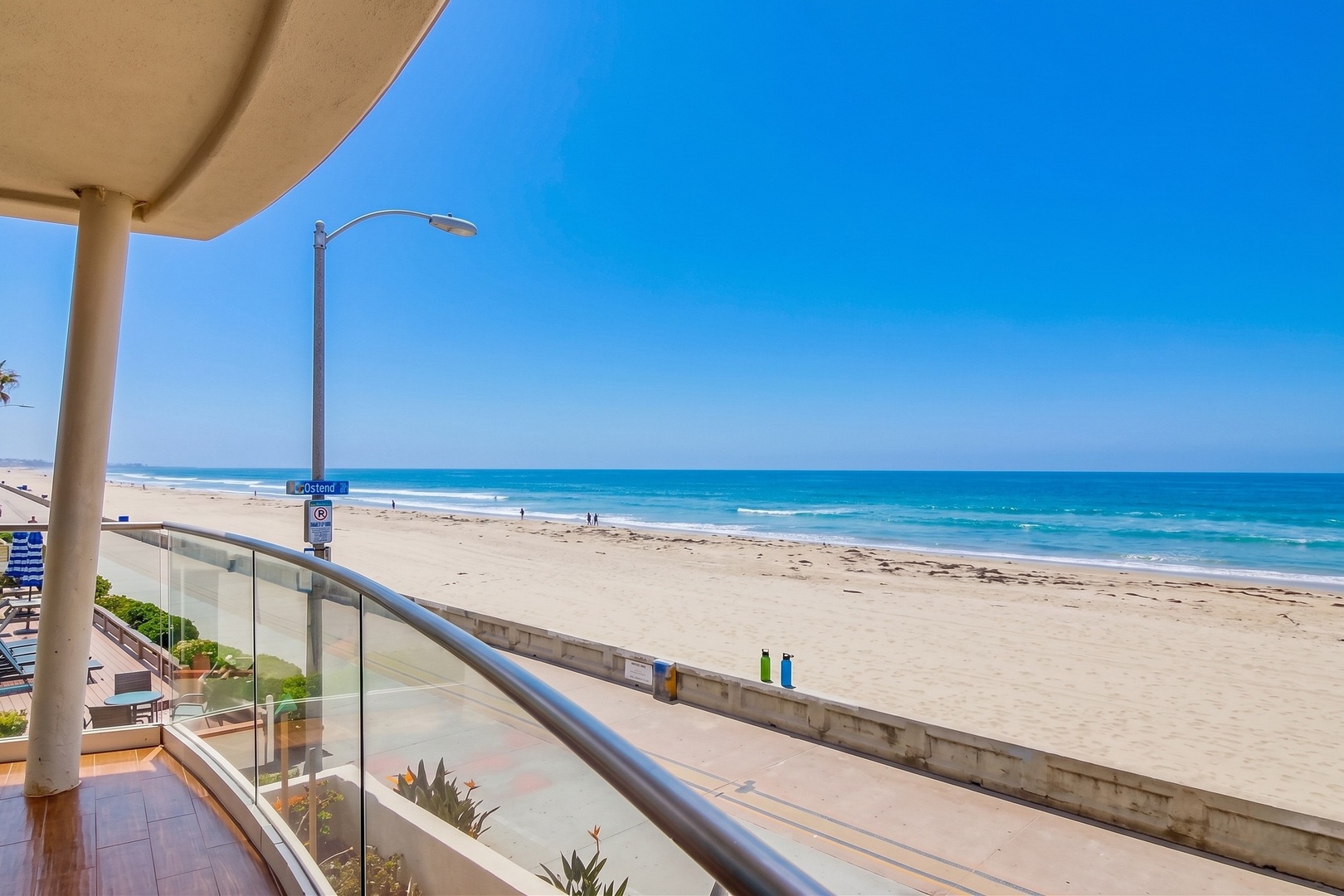 This beachfront rental offers direct access to pristine sandy shores and sparkling turquoise waters. Watch the waves roll in from your private balcony, just steps from the surf and sun.