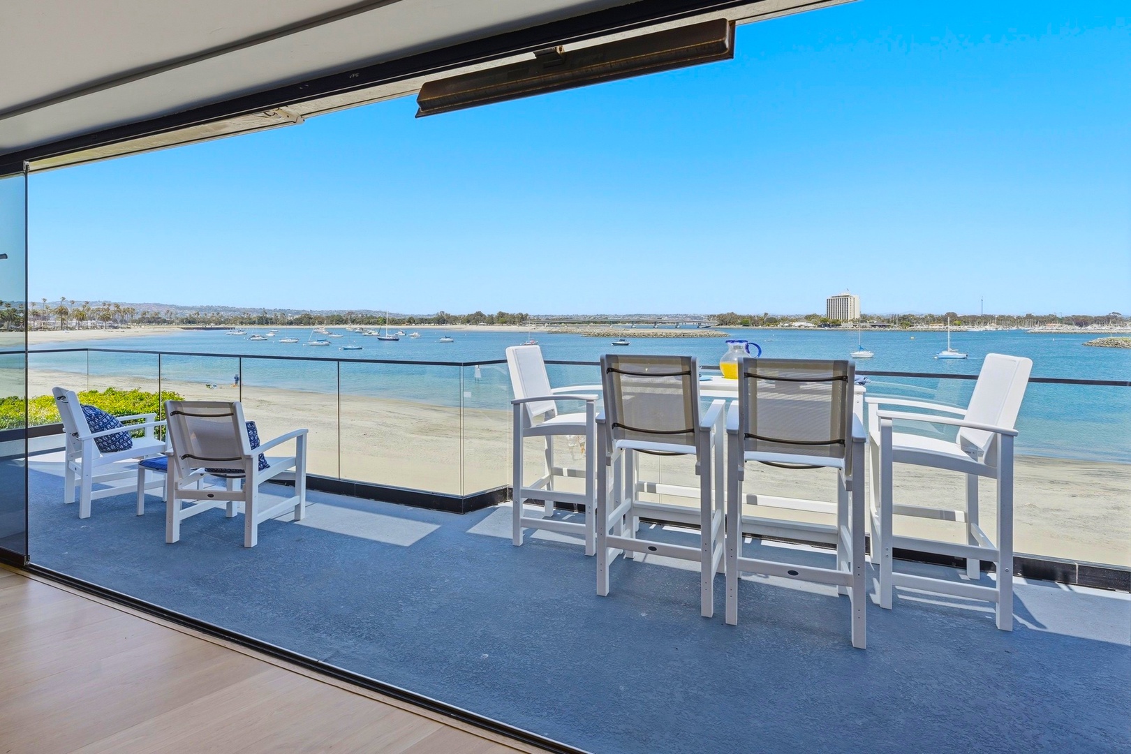 Step onto your private balcony and settle into stunning bay views. Enjoy morning coffee or evening drinks at your outdoor table while sailboats drift by.