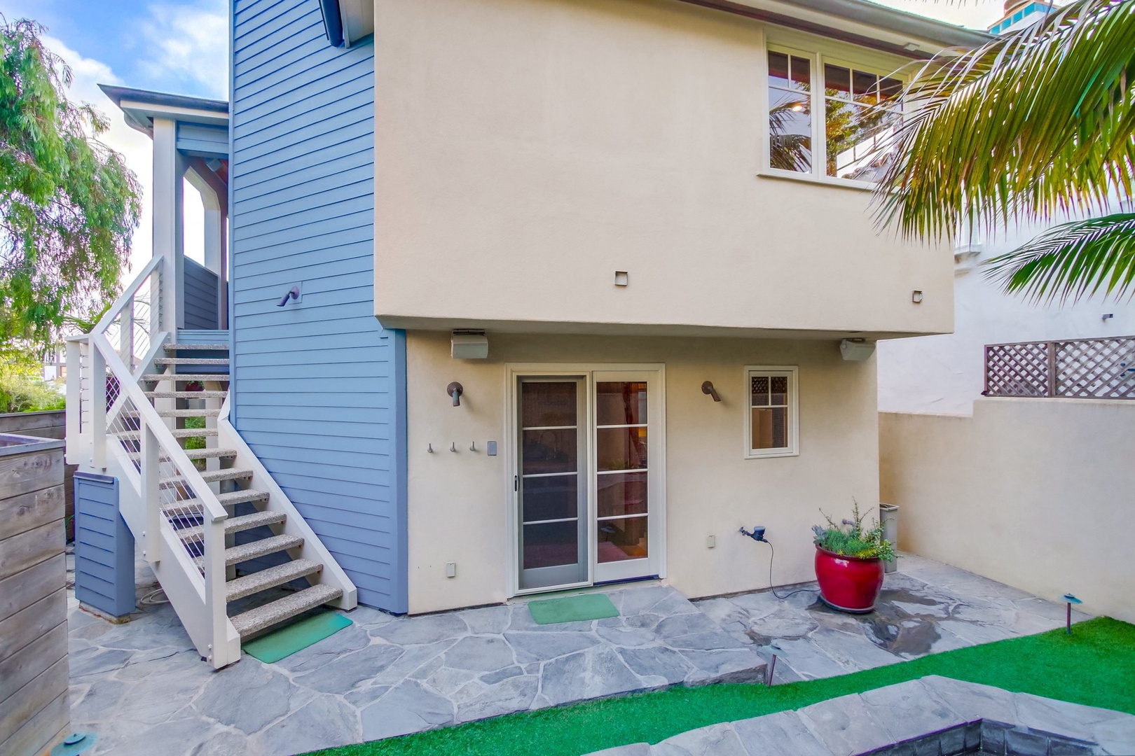 Rear patio with stairs to the main level