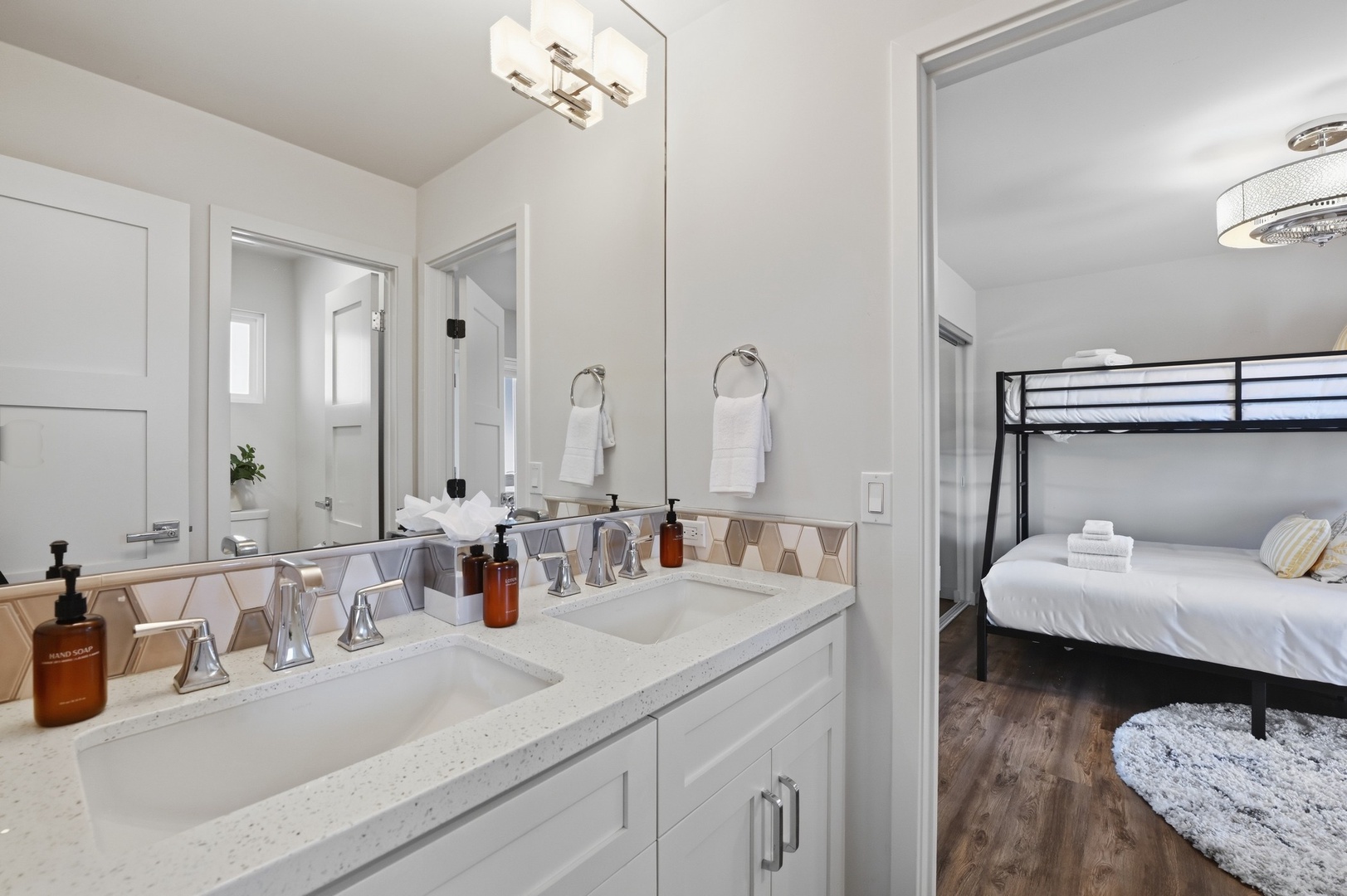 Freshen up in your sleek bathroom with premium amenities and modern fixtures, just steps from your cozy sleeping space.