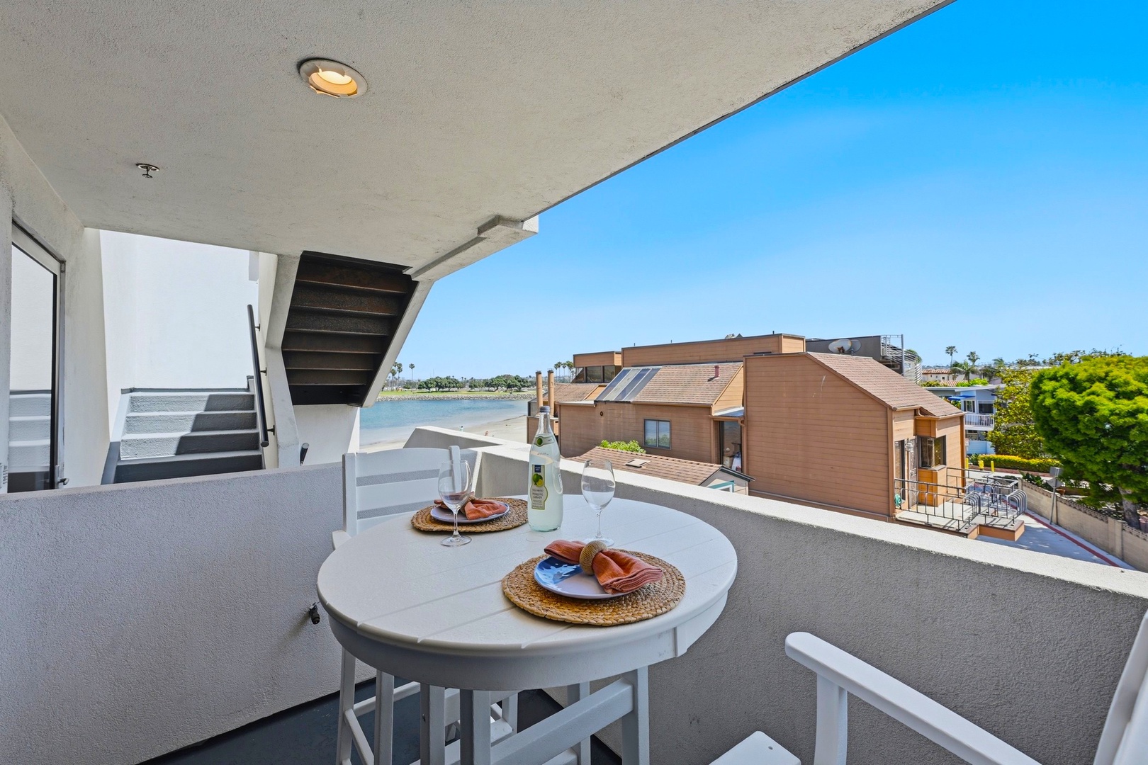 Coastal balcony with bay views and bistro seating