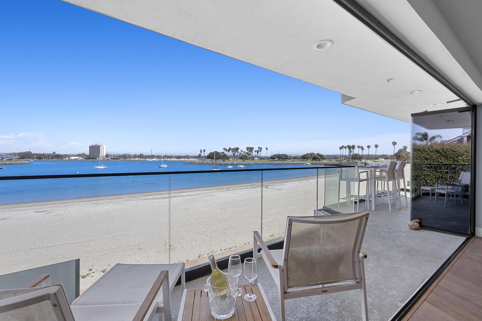 Waterfront living at its finest: serene bay views, soft sandy shores, and swaying palms frame your daily escape. Enjoy sun-soaked mornings and breezy afternoons from your private terrace.