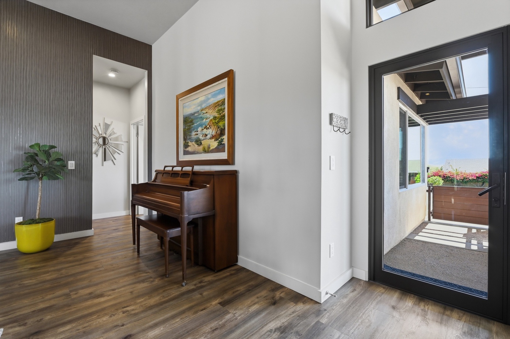 Your living space opens to a private balcony, featuring elegant decor and a charming piano for memorable evenings.