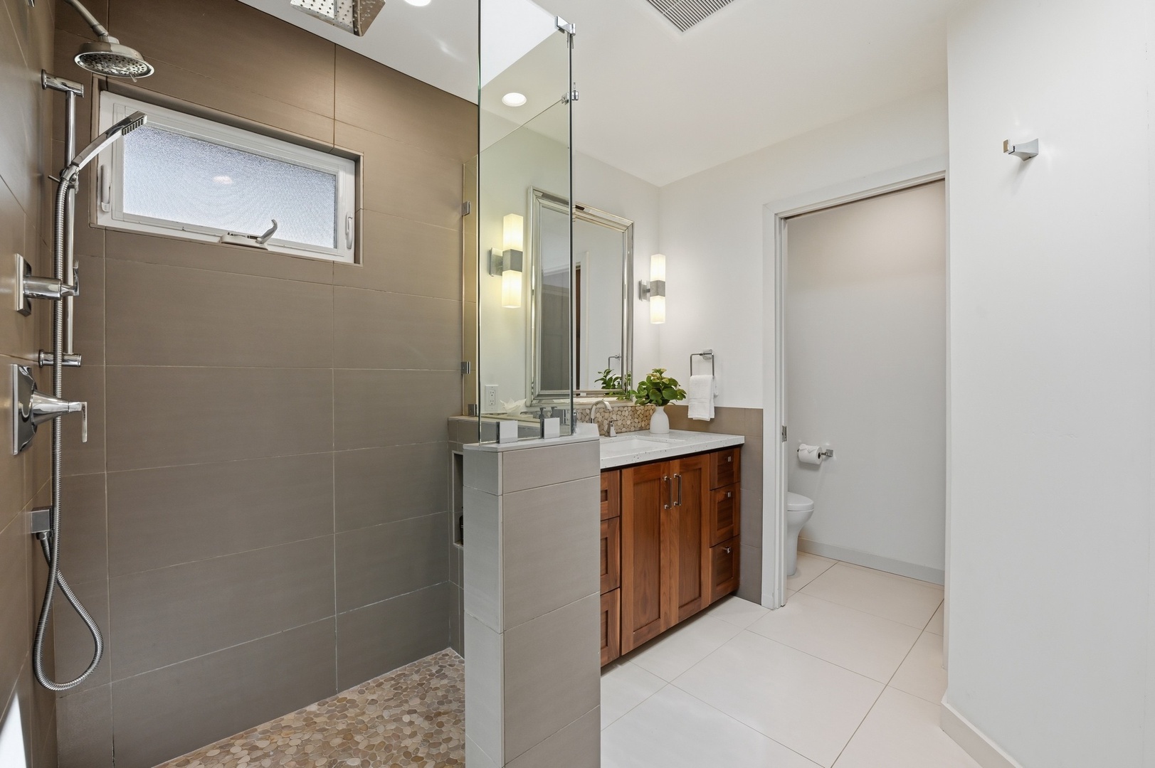 Step into your modern spa-like bathroom with spacious walk-in shower and elegant vanity for relaxing morning routines.