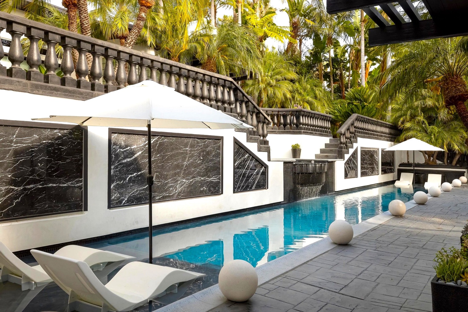 You'll love lounging by your private pool, surrounded by lush tropical palms and elegant marble accents in this sophisticated oasis.