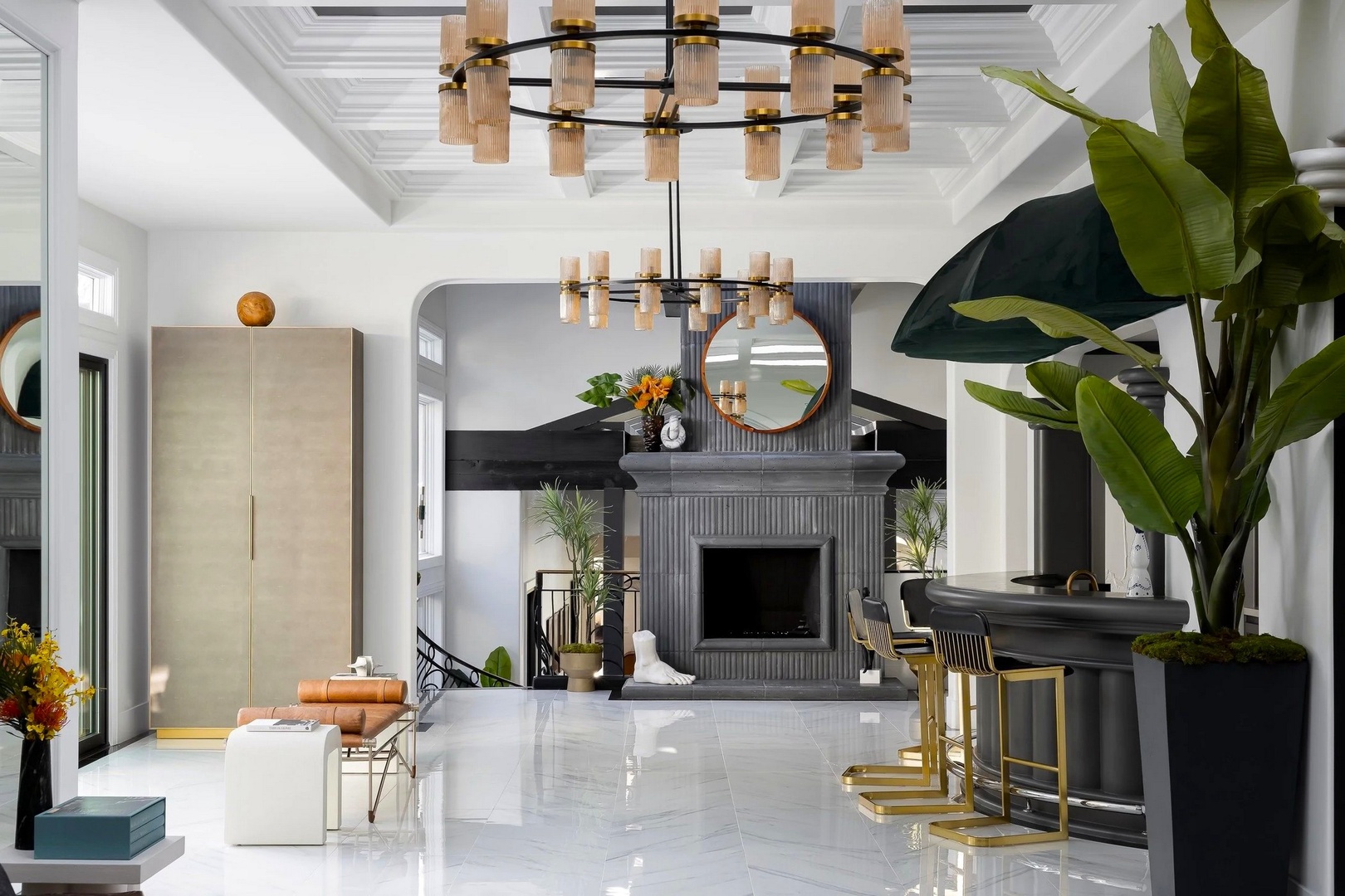 Relax in this stunning living space with soaring coffered ceilings, elegant chandelier lighting, and a cozy fireplace centerpiece.