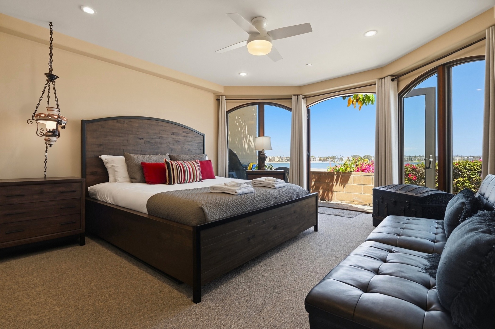 Sink into luxurious comfort in your primary suite with stunning water views and elegant furnishings for perfect relaxation.