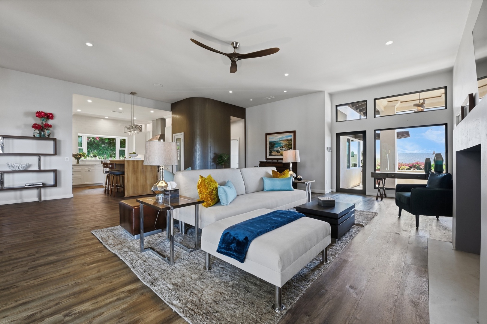 Sink into this spacious open-concept living area where modern comfort meets style. Large windows flood your space with natural light while you relax on the plush sectional.