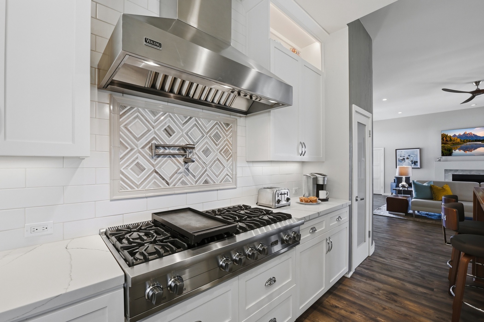 Your chef-quality kitchen features Viking appliances, marble counters, and elegant backsplash for memorable meals.