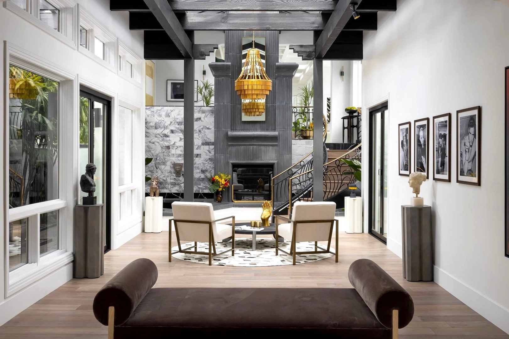 Unwind in your sophisticated living space featuring a stunning chandelier, cozy fireplace, and elegant seating perfect for memorable evenings.
