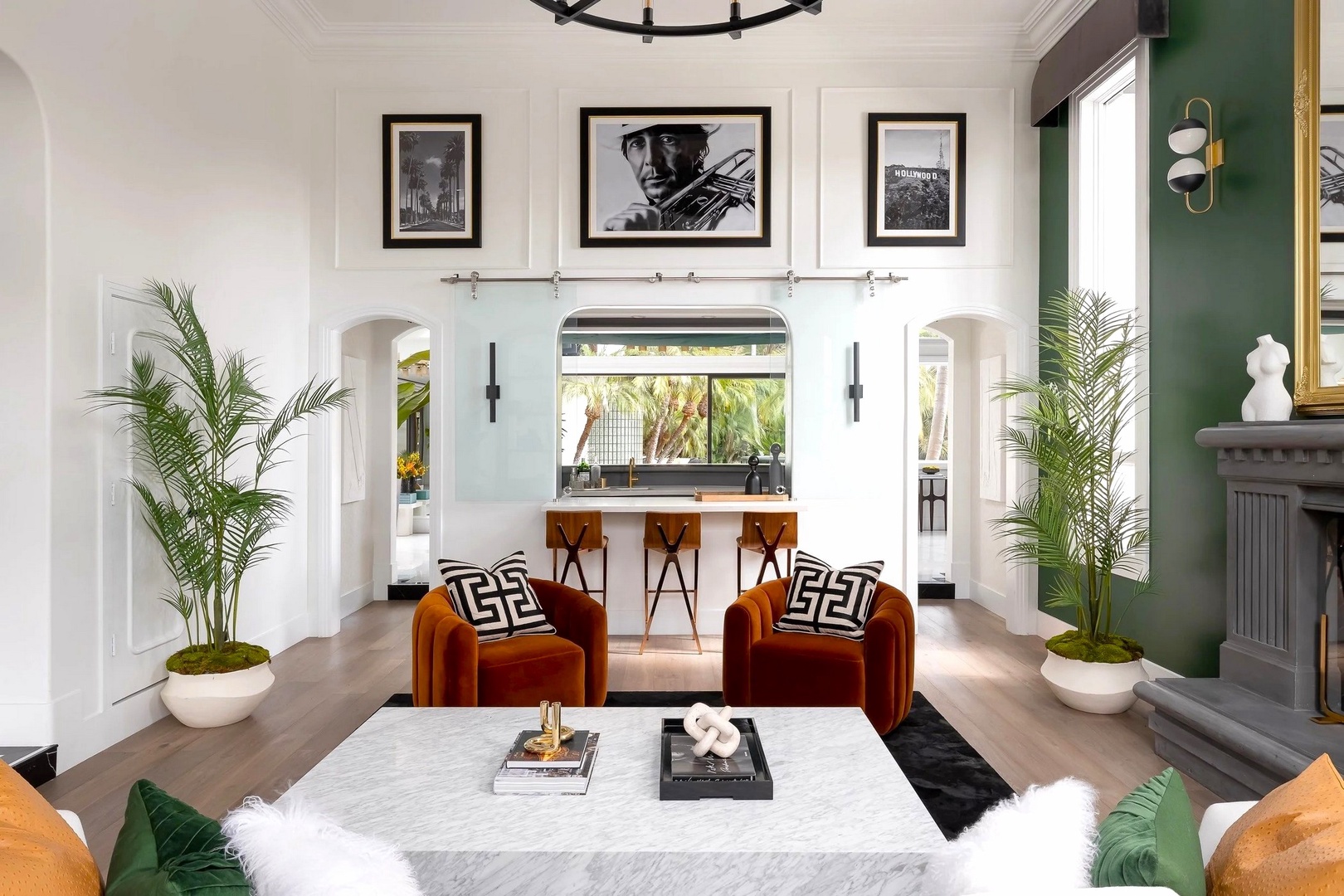 Unwind in this sophisticated living space where rich velvet seating and tropical palms create your perfect retreat.