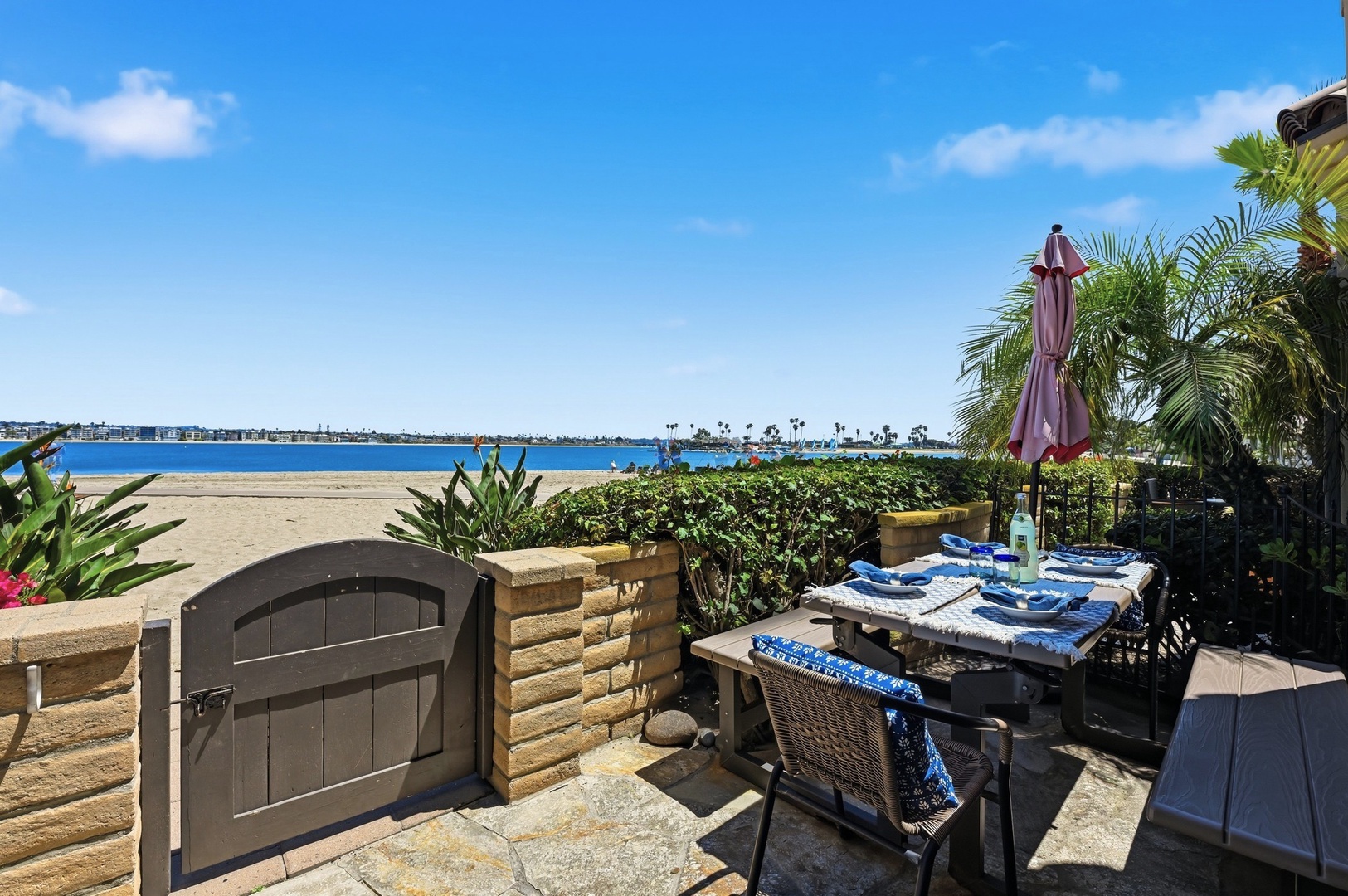 Step through your private gate to pristine beach access, where palm-fringed shores meet crystal waters just steps from your patio.