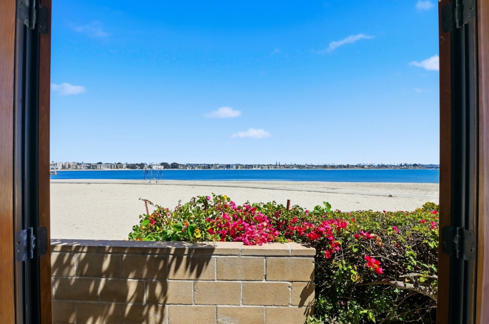 Wake up to stunning beachfront views from your window, where vibrant blooms frame pristine sand and sparkling blue waters.