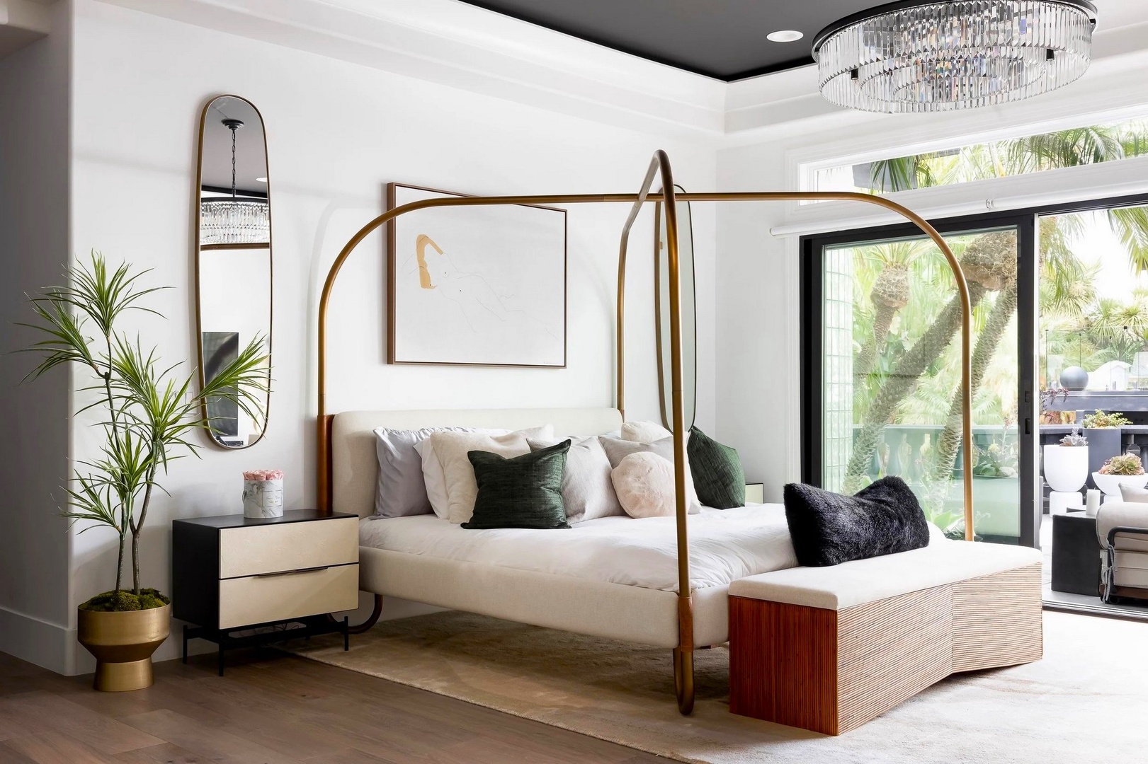 Slip into luxury with this stunning four-poster bed featuring crisp linens and plush pillows, all beneath a dazzling chandelier.