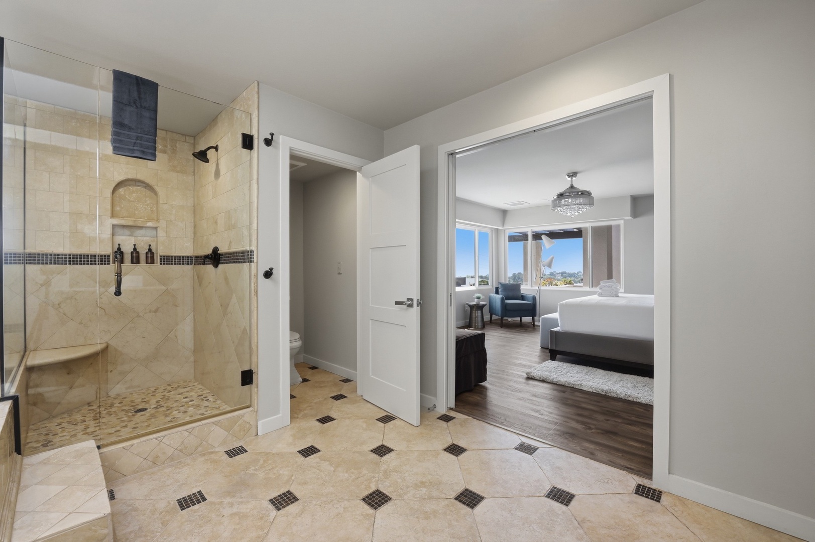 Your elegant bathroom features luxurious travertine tile and a spacious glass shower, creating a spa-like retreat for unwinding after your adventures.