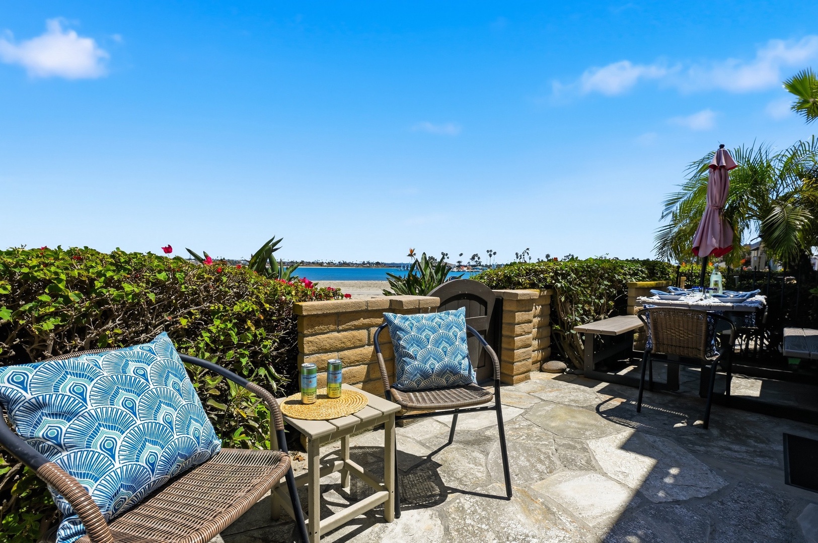Relax on your private Bayside Walk patio with beach views and comfortable seating just steps from the sparkling water.