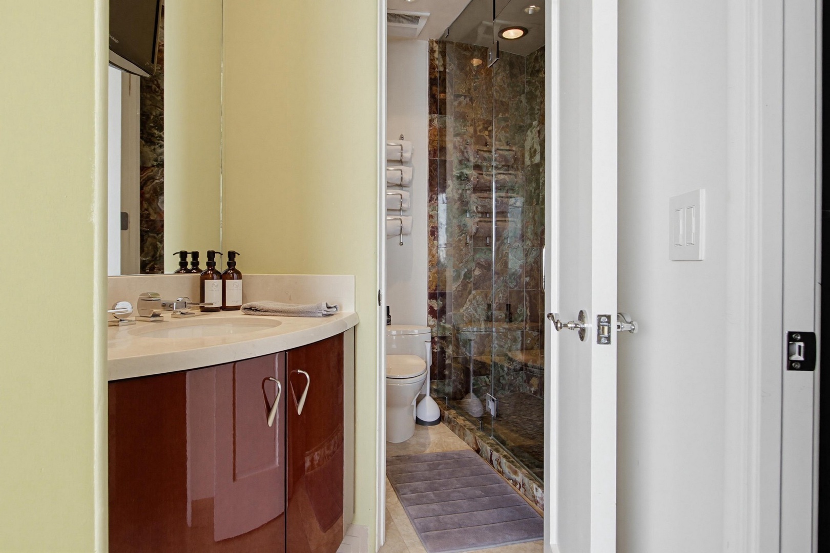 Bathroom features a sleek glass-enclosed shower