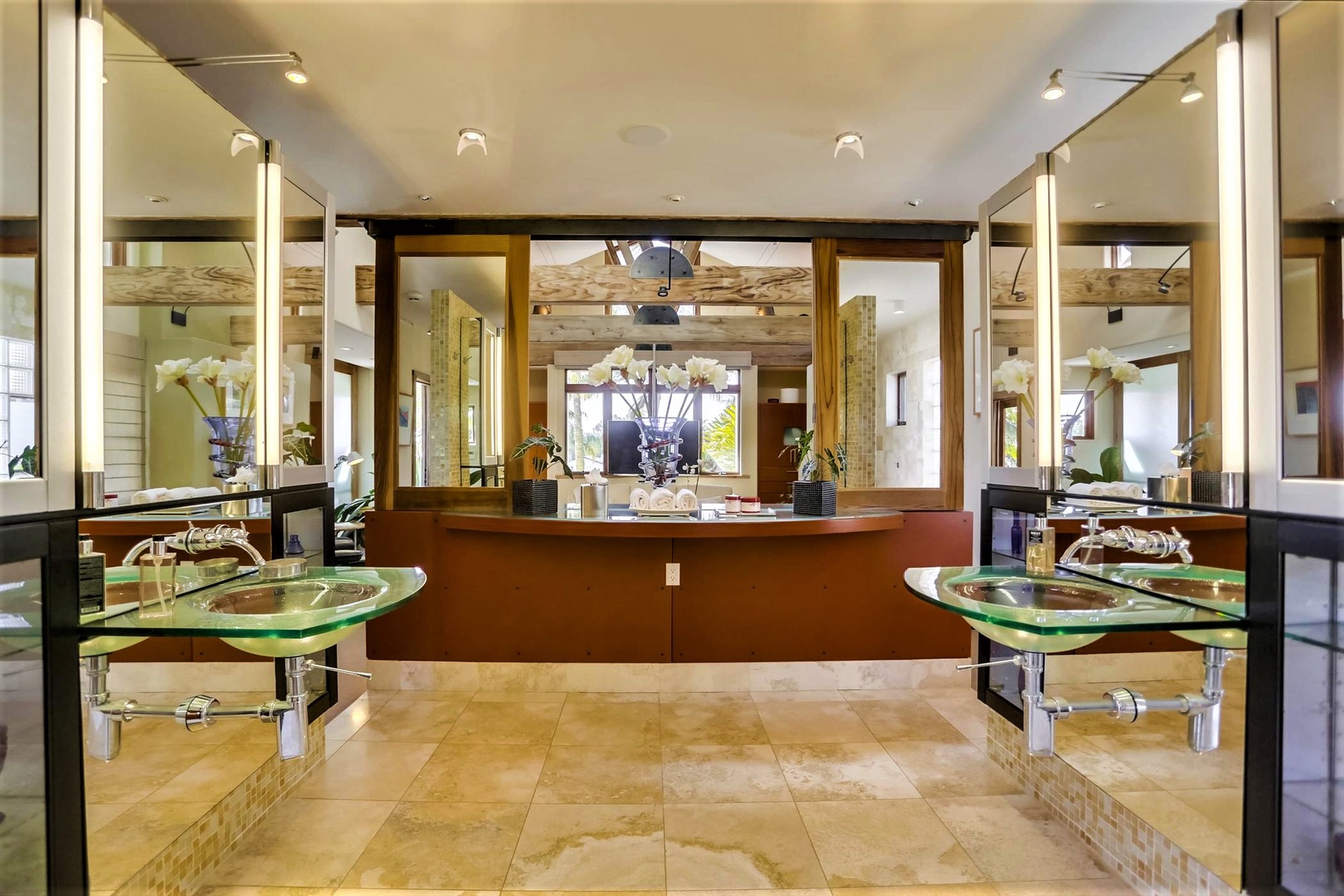 En suite bathroom featuring dual glass sinks