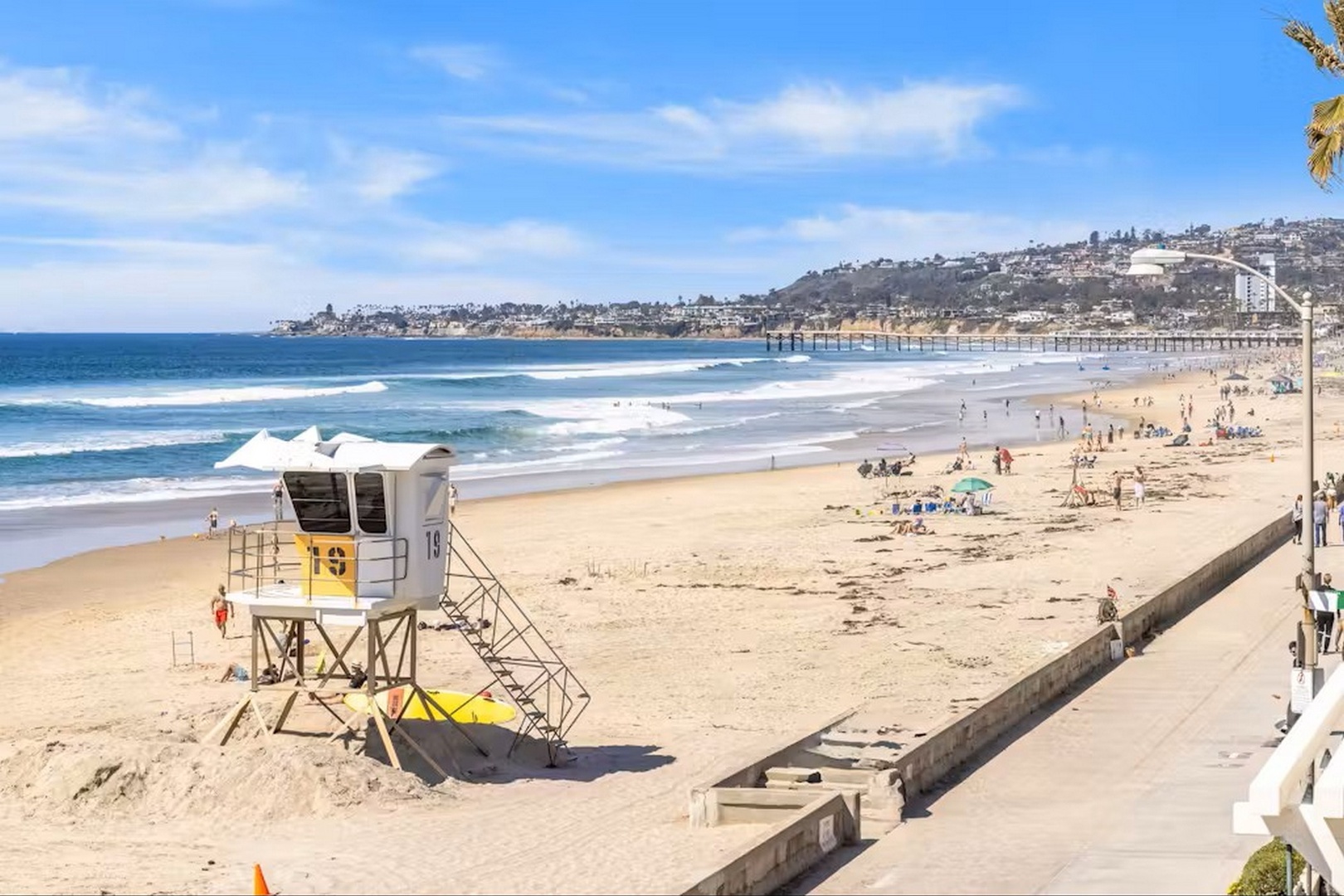 Sweeping coastal beach with golden sand, rolling waves, and hillside views stretches along the shore near the property, offering a scenic backdrop for your coastal getaway.