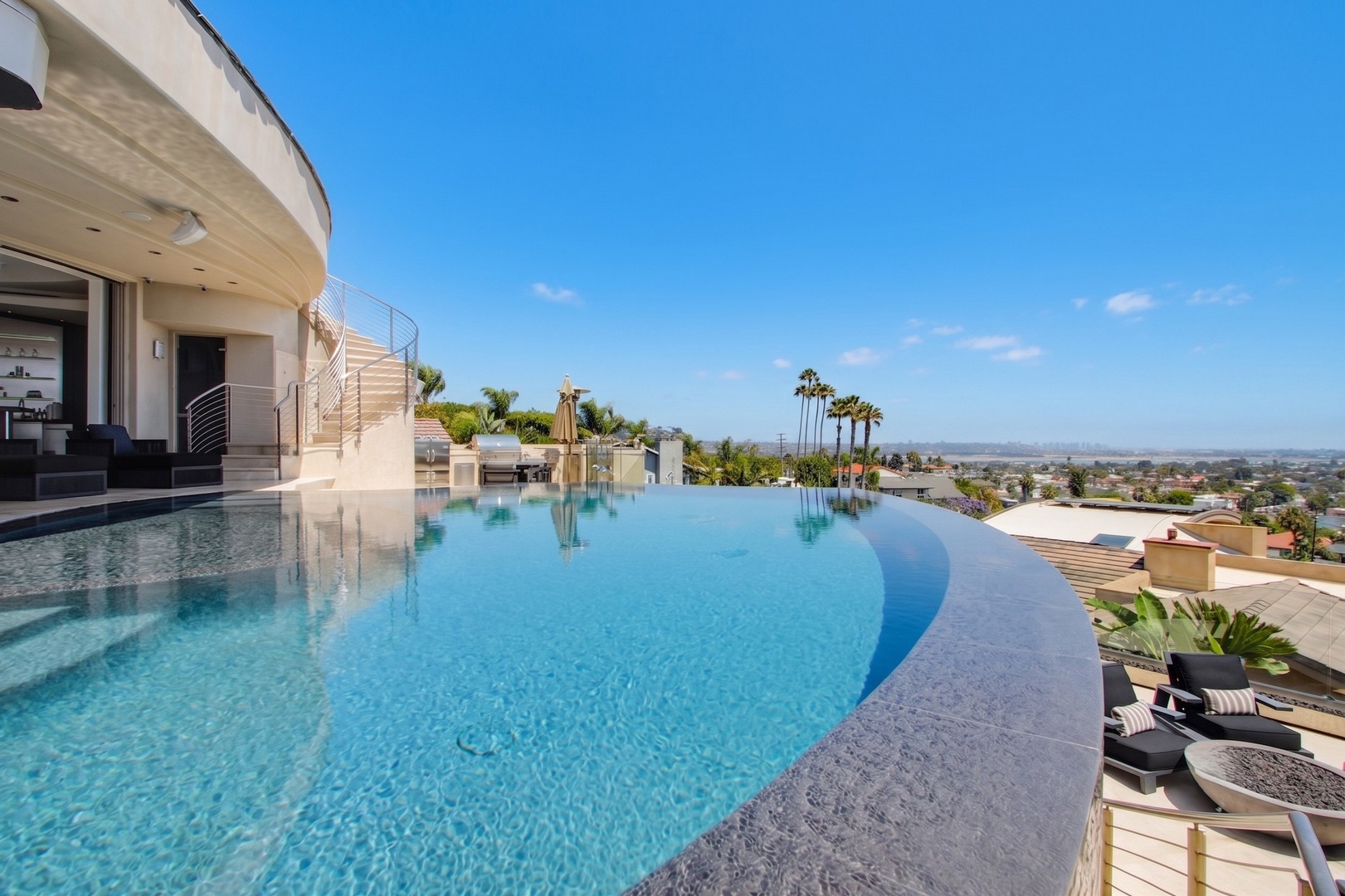 Deep blue pool with panoramic coastal views