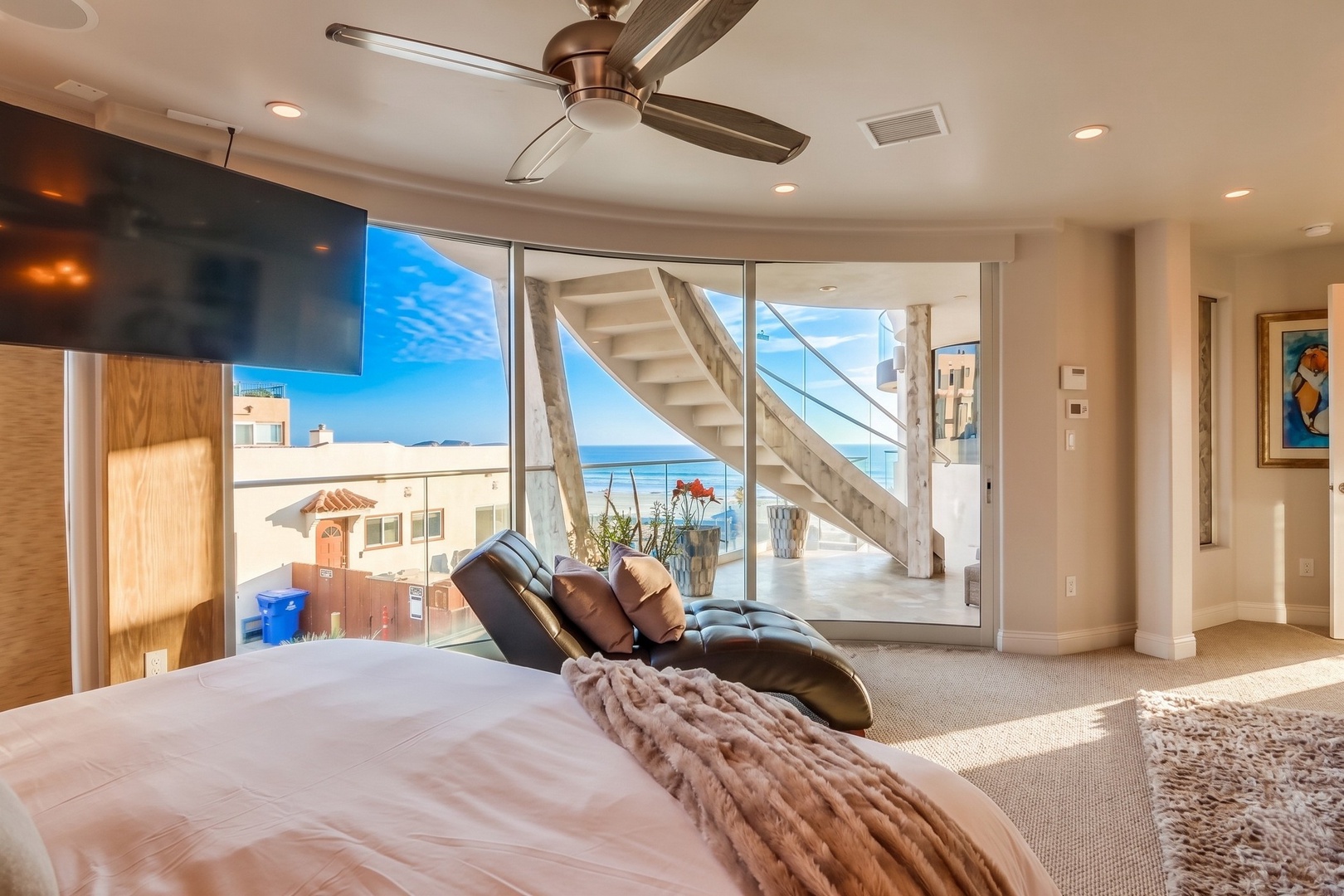 Wake up to stunning ocean views from your bed. Bright, airy space with modern comforts, a cozy chaise lounge, and direct access to the terrace.