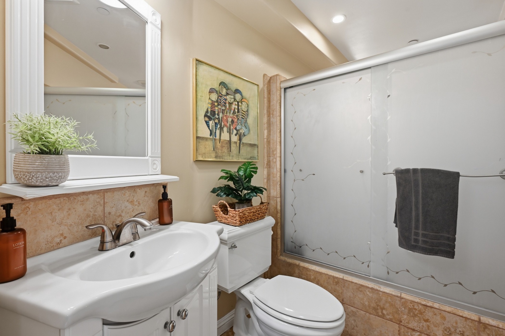 Unwind in your elegant bathroom featuring marble accents, fresh greenery, and a spacious walk-in shower for your perfect retreat.